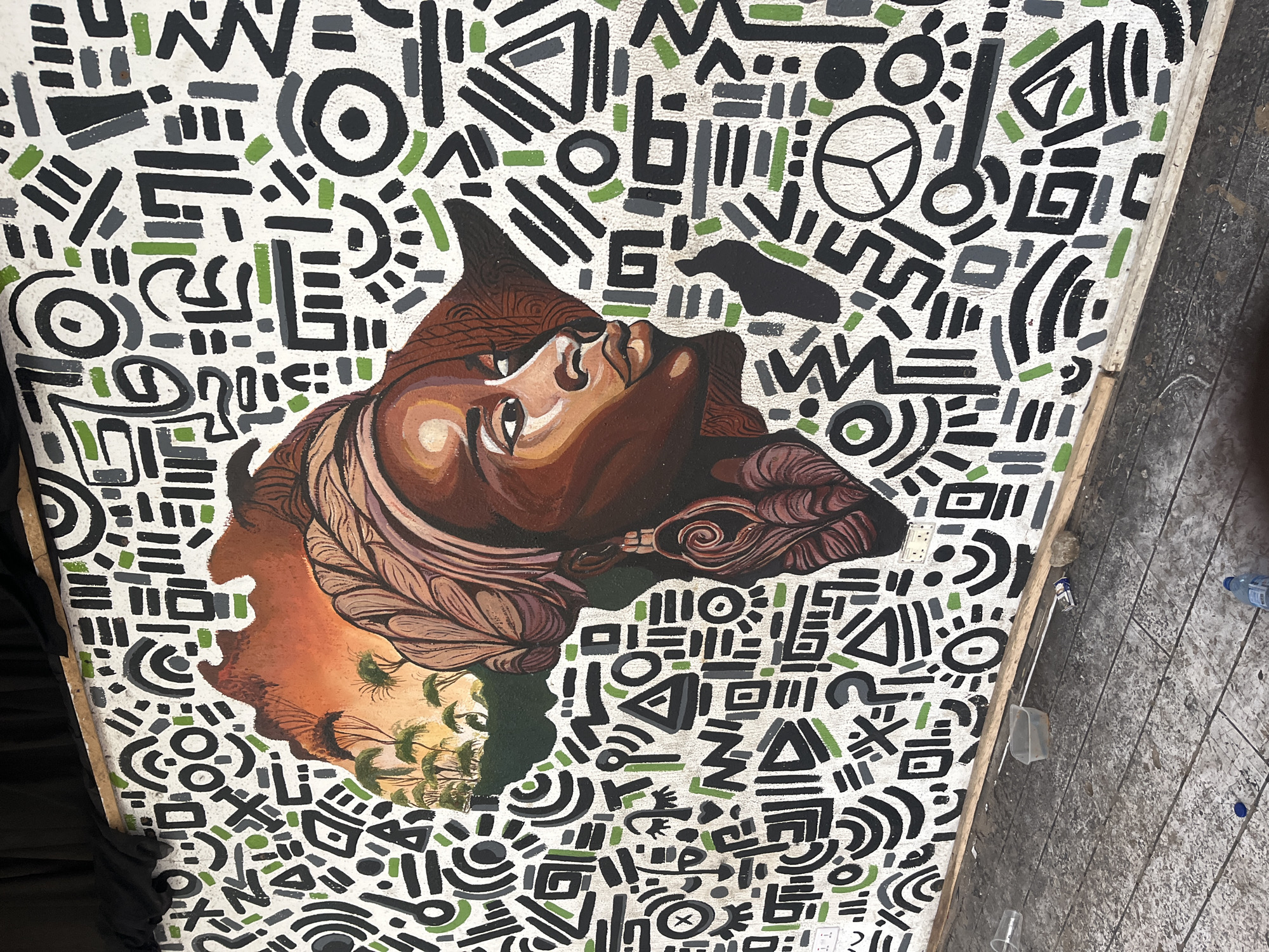 Framed portrait mural documented on white wall