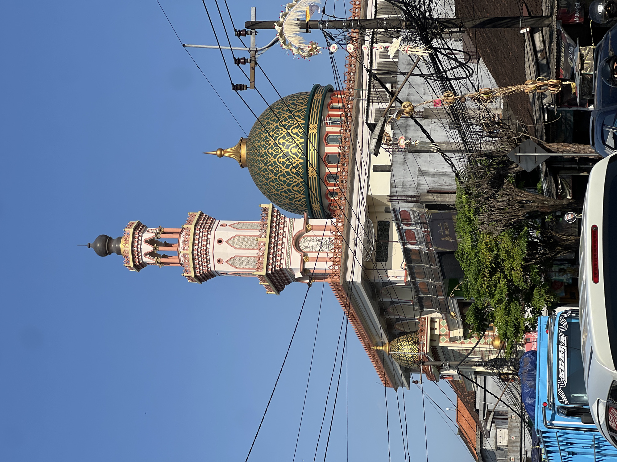 Mosque and Hindu-Buddhist statue coexist in Kediri, Indonesia