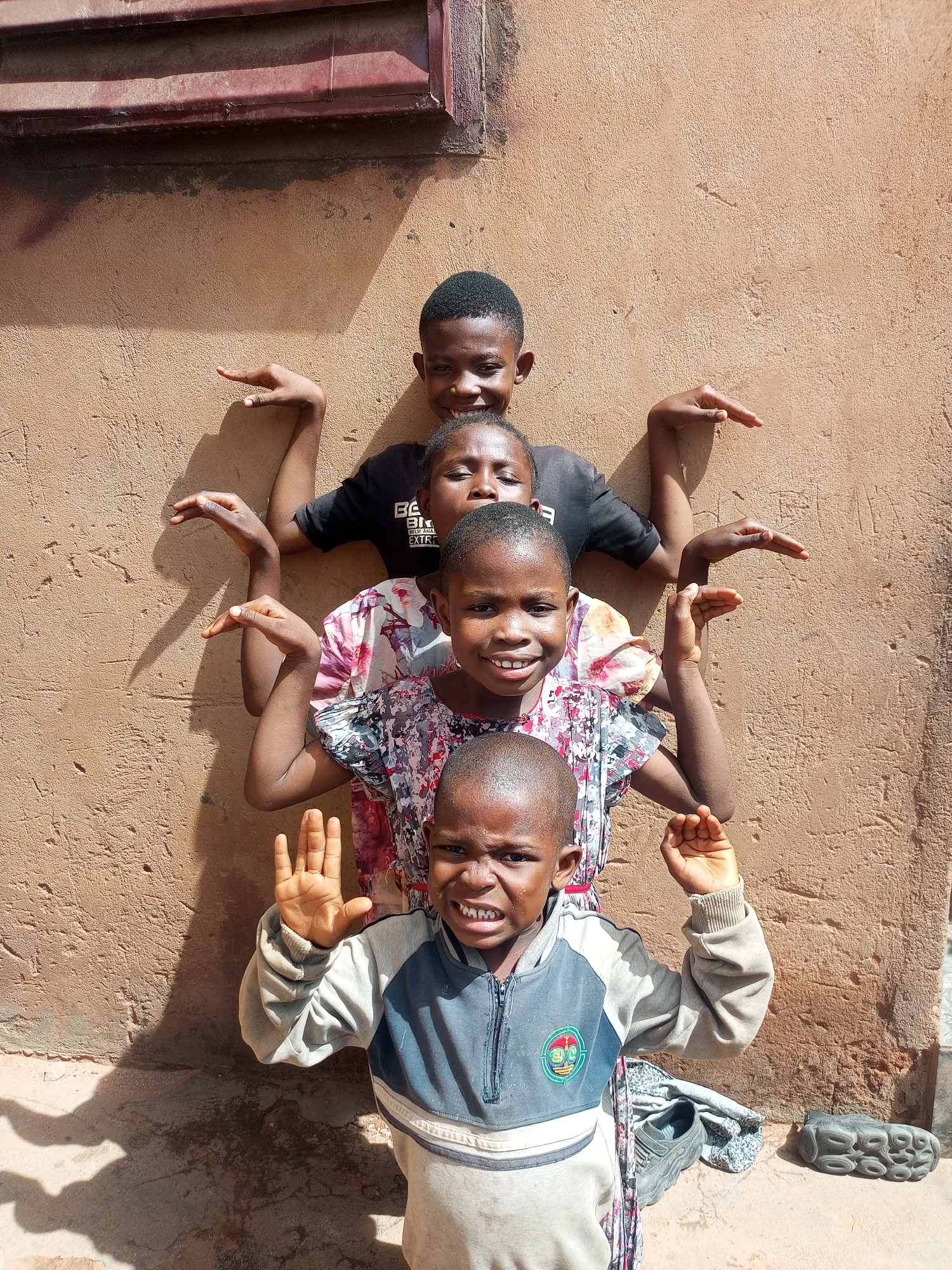 Children play against wall in Tempure, Nigeria