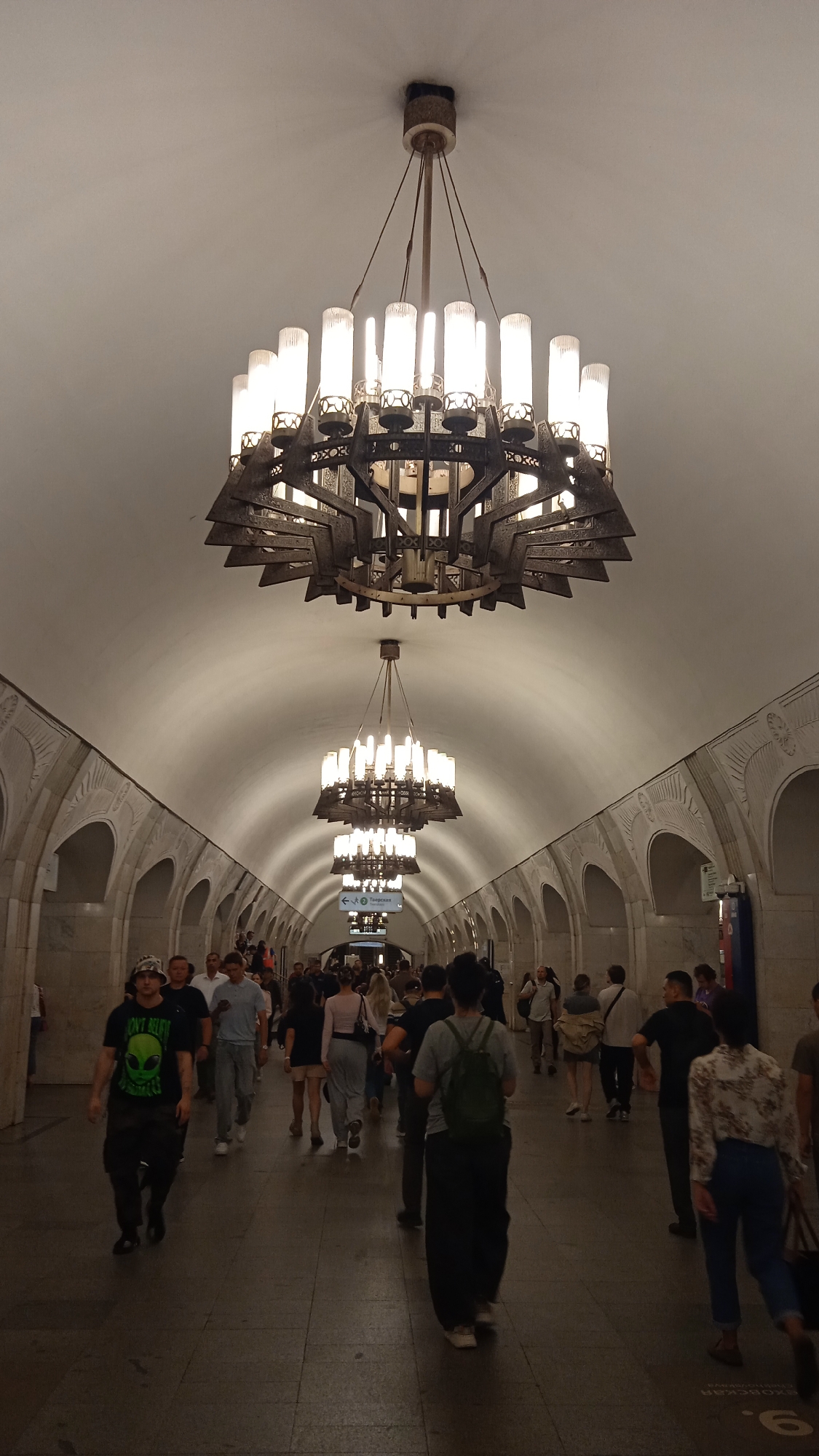 Inside an elaborately decorated metro station with a waiting train