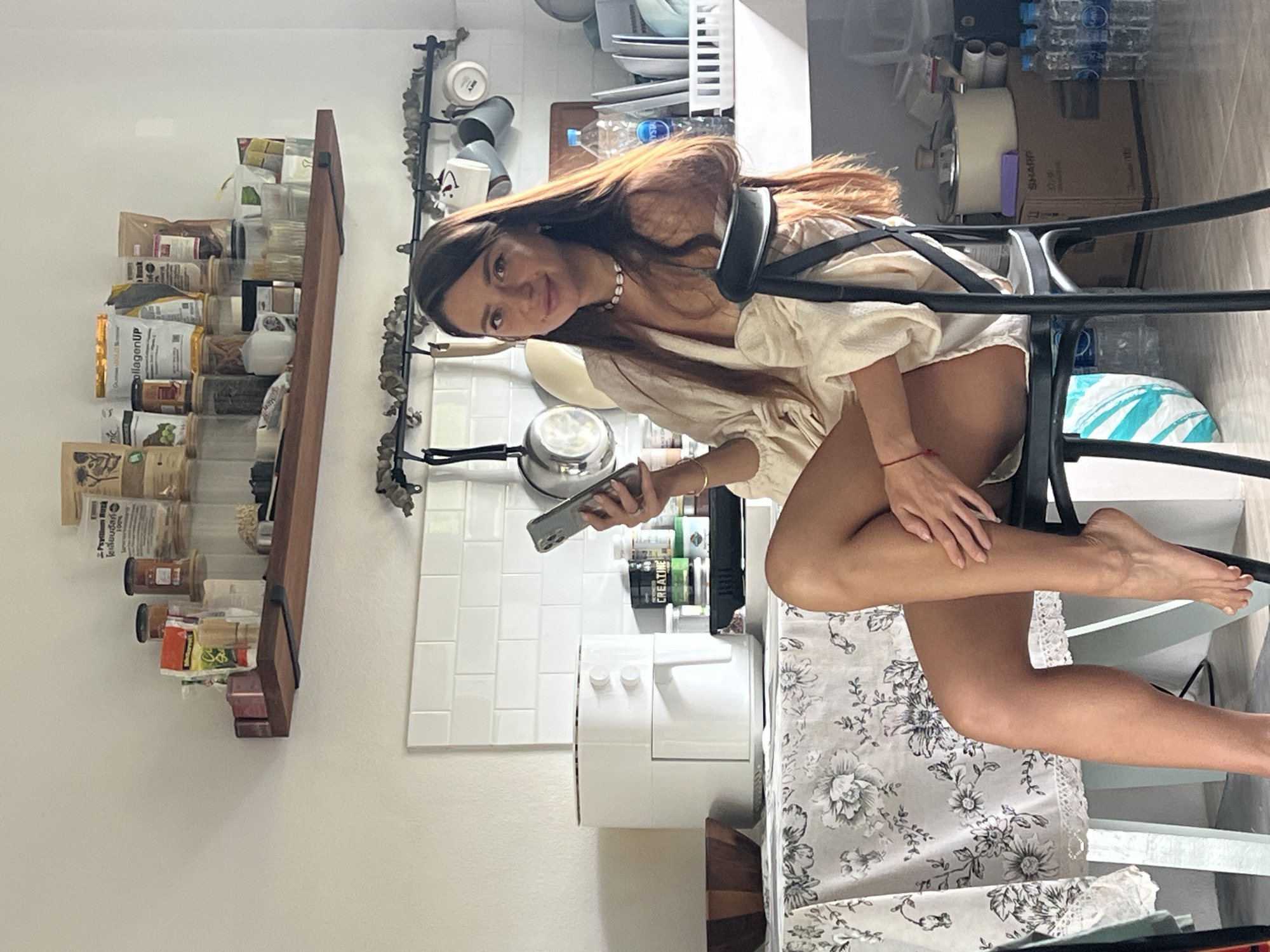 Woman uses phone in kitchen, บ้านบางรักษ์, Thailand