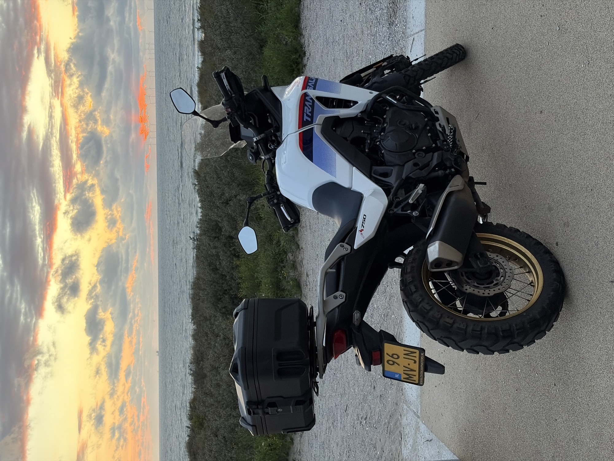 Honda Transalp parked at North Sea sunset near The Hague