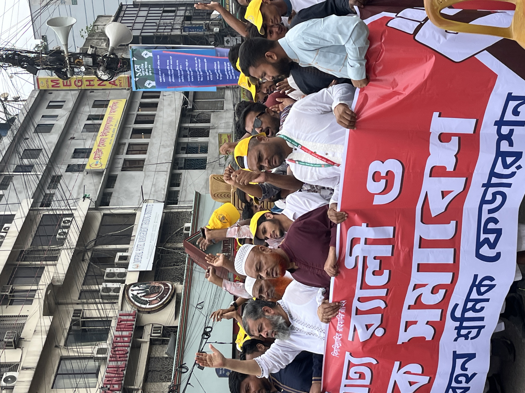 Men in traditional attire gather for demonstration in Dhaka