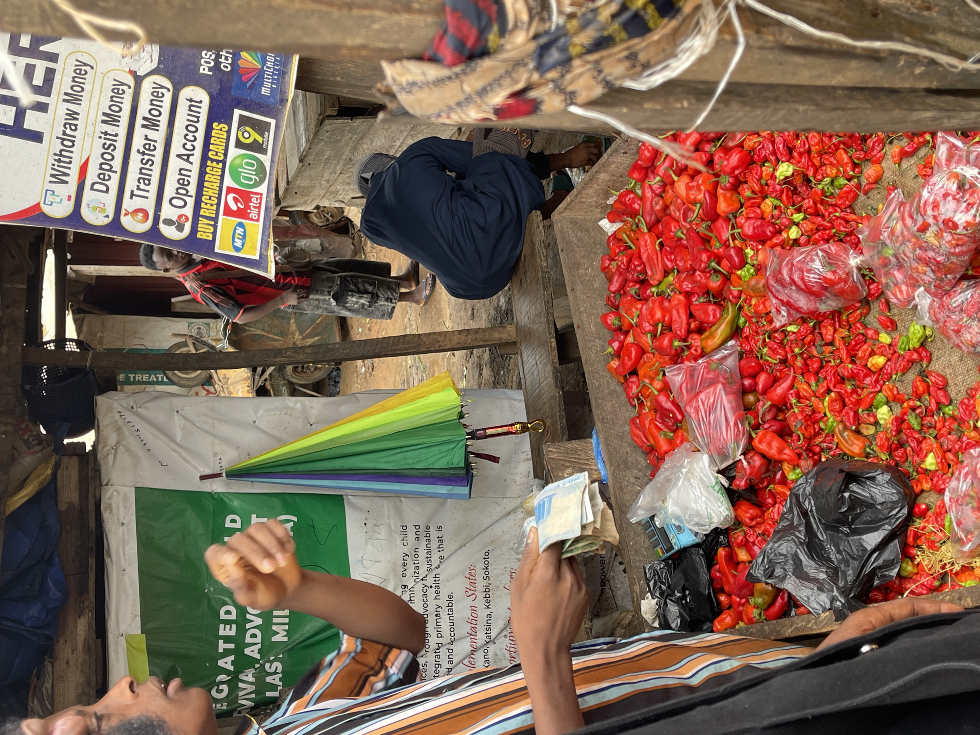 Morning market activity across produce and meat stalls in Abuja