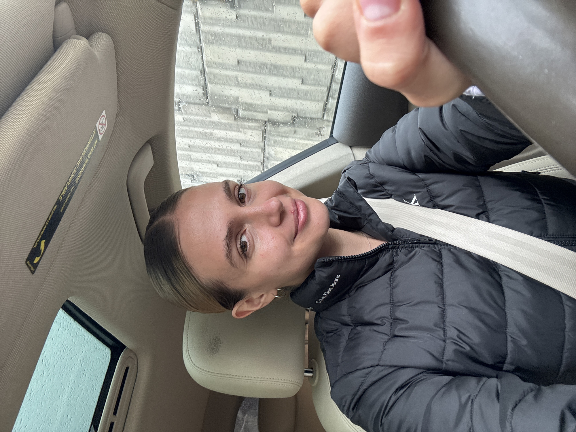 Woman takes driving selfie in Tbilisi vehicle