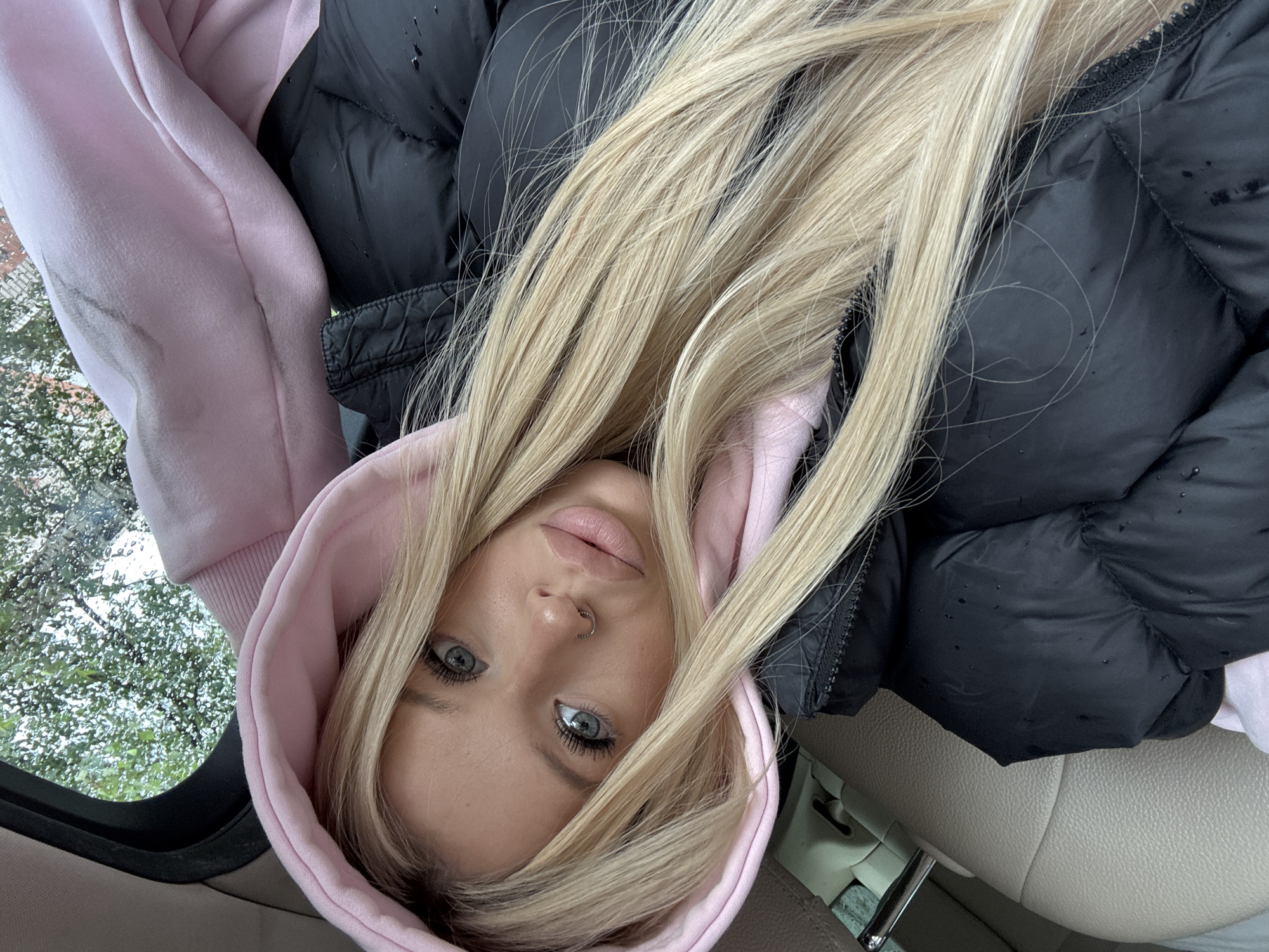 Selfies and a Mercedes emblem shot from inside a St. Petersburg car