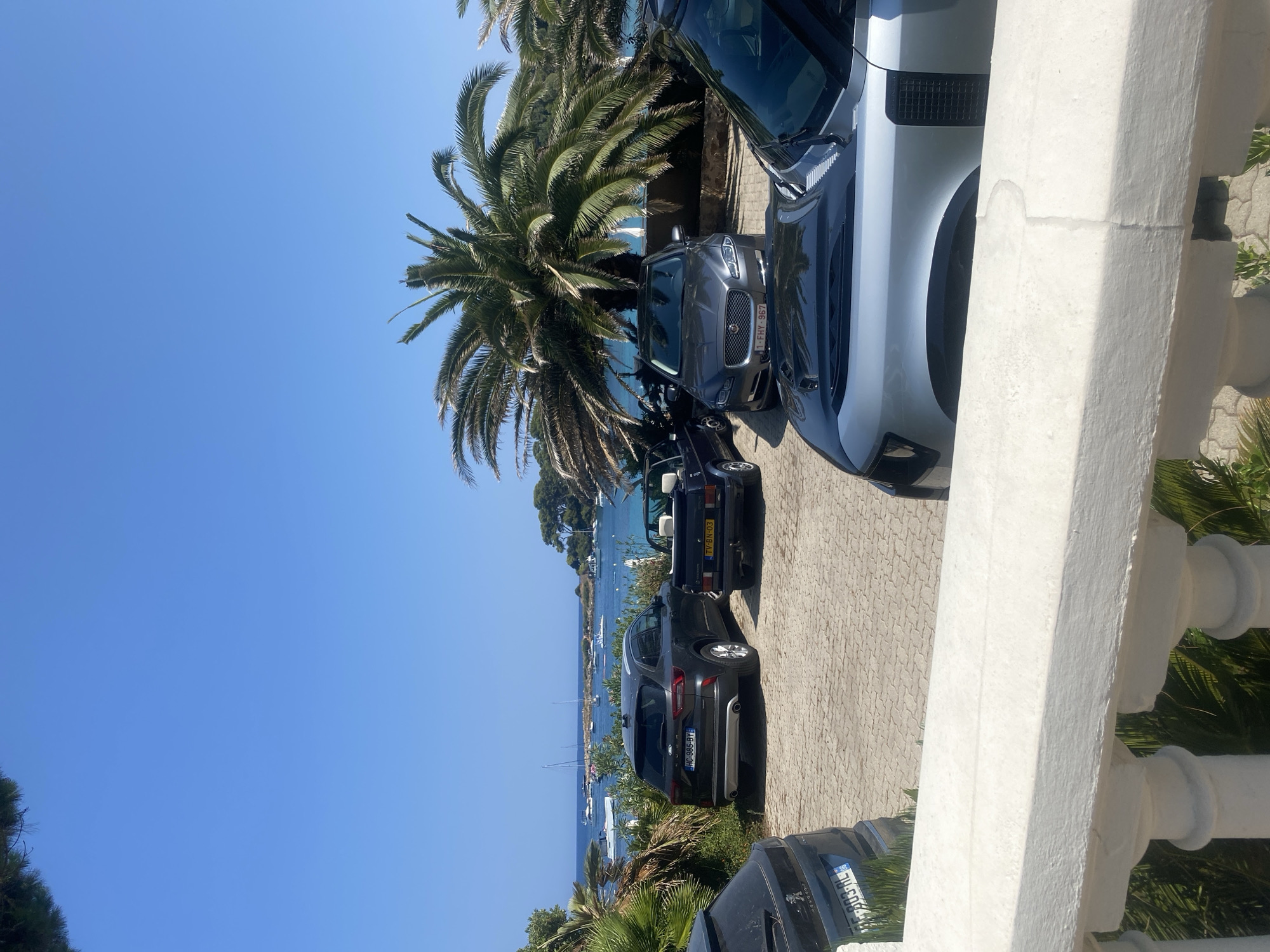 Coastal villas, rocky shoreline, and anchored yachts in Antibes
