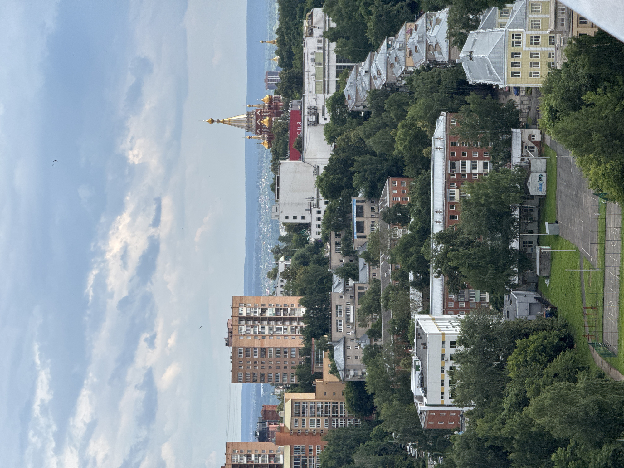 Izhevsk cityscape: old architecture, green canopy, active construction