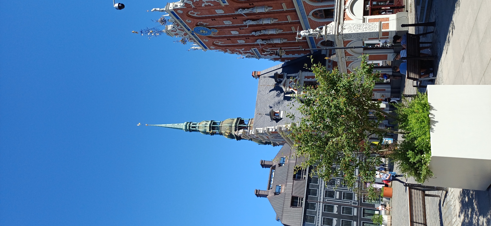 Sunny afternoon in a European city square with street sculpture