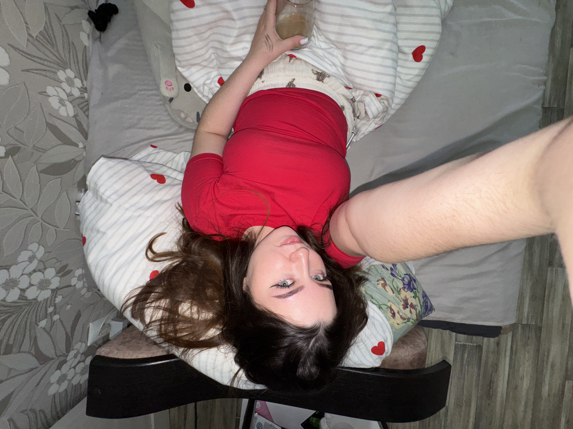Woman Takes Selfie While Lying Down in Гамово