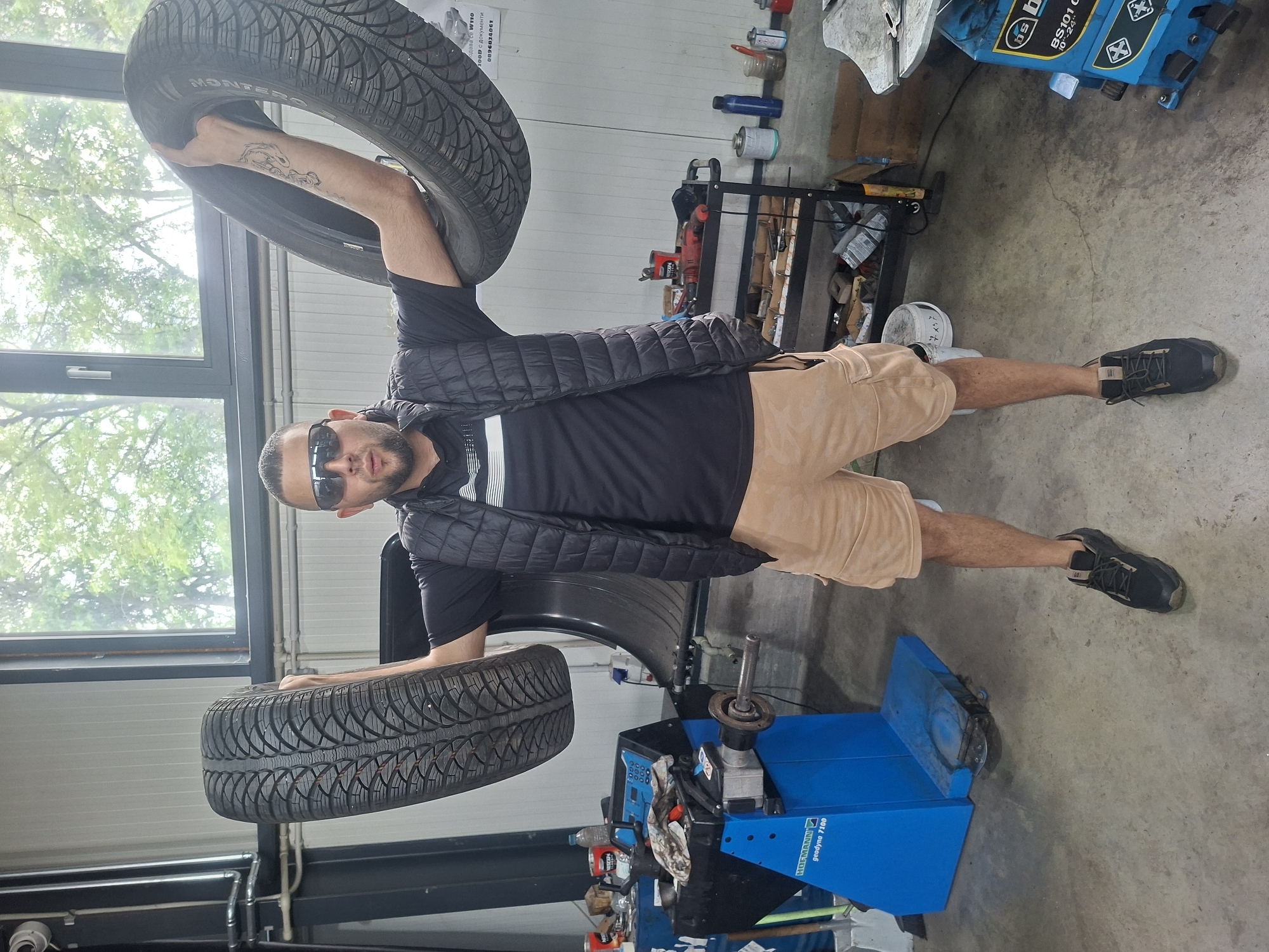 Tire shop worker prepares for weather as rain hits area