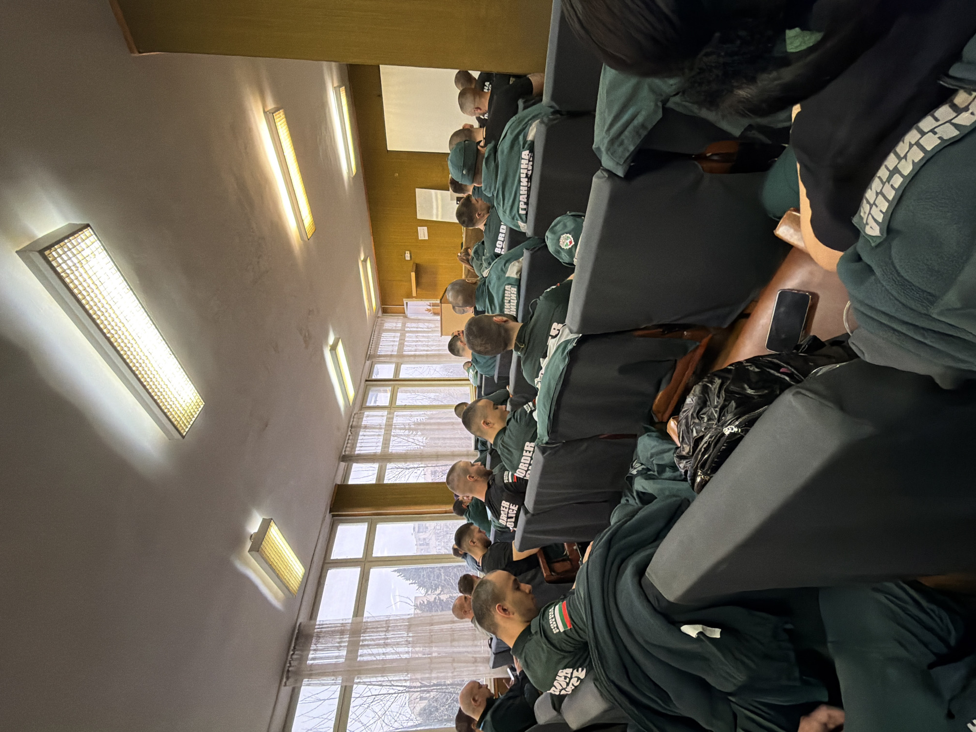 Young men in green gather in Pazardzhik auditorium