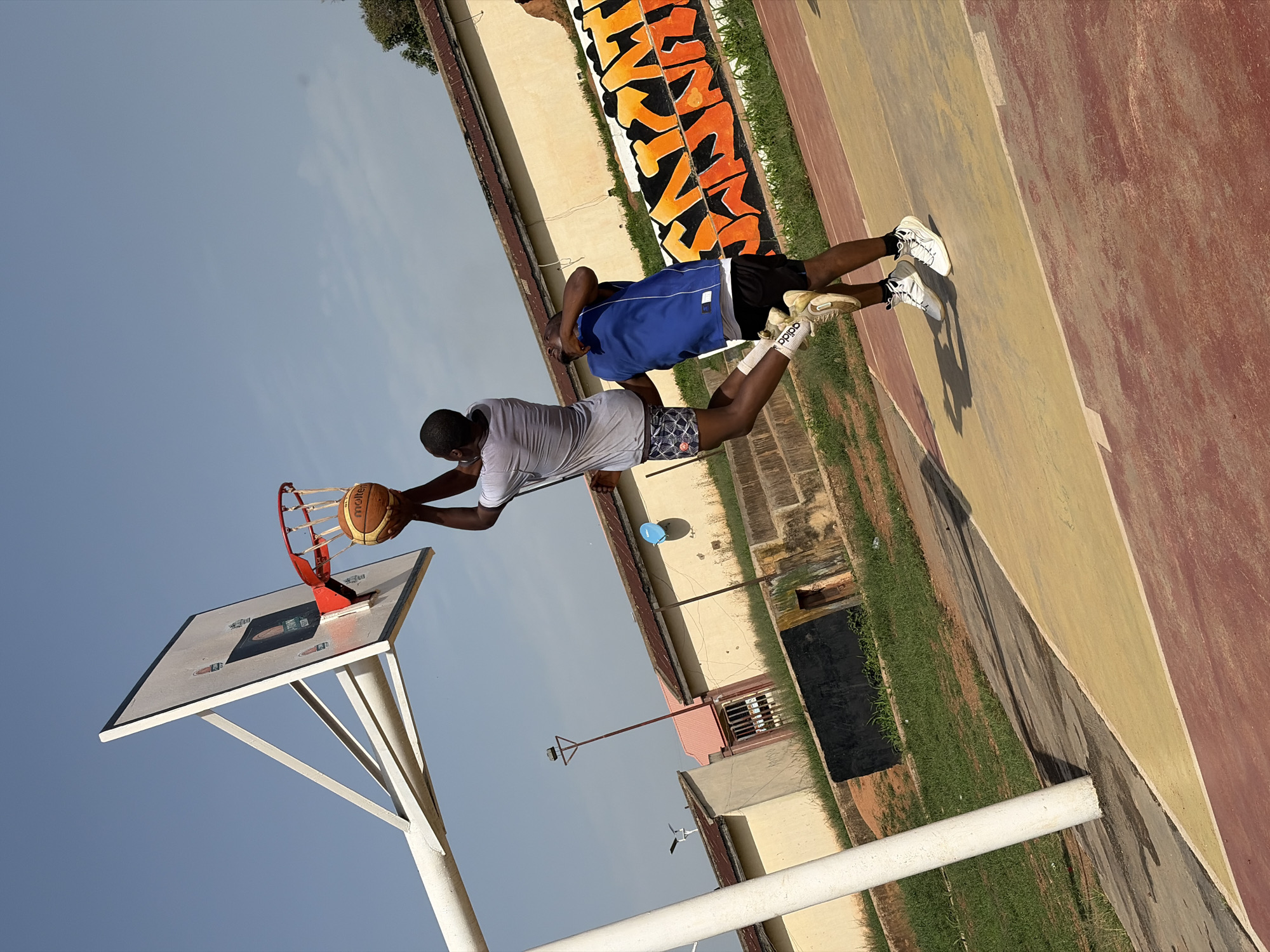 Morning basketball game captured on outdoor court in Jos