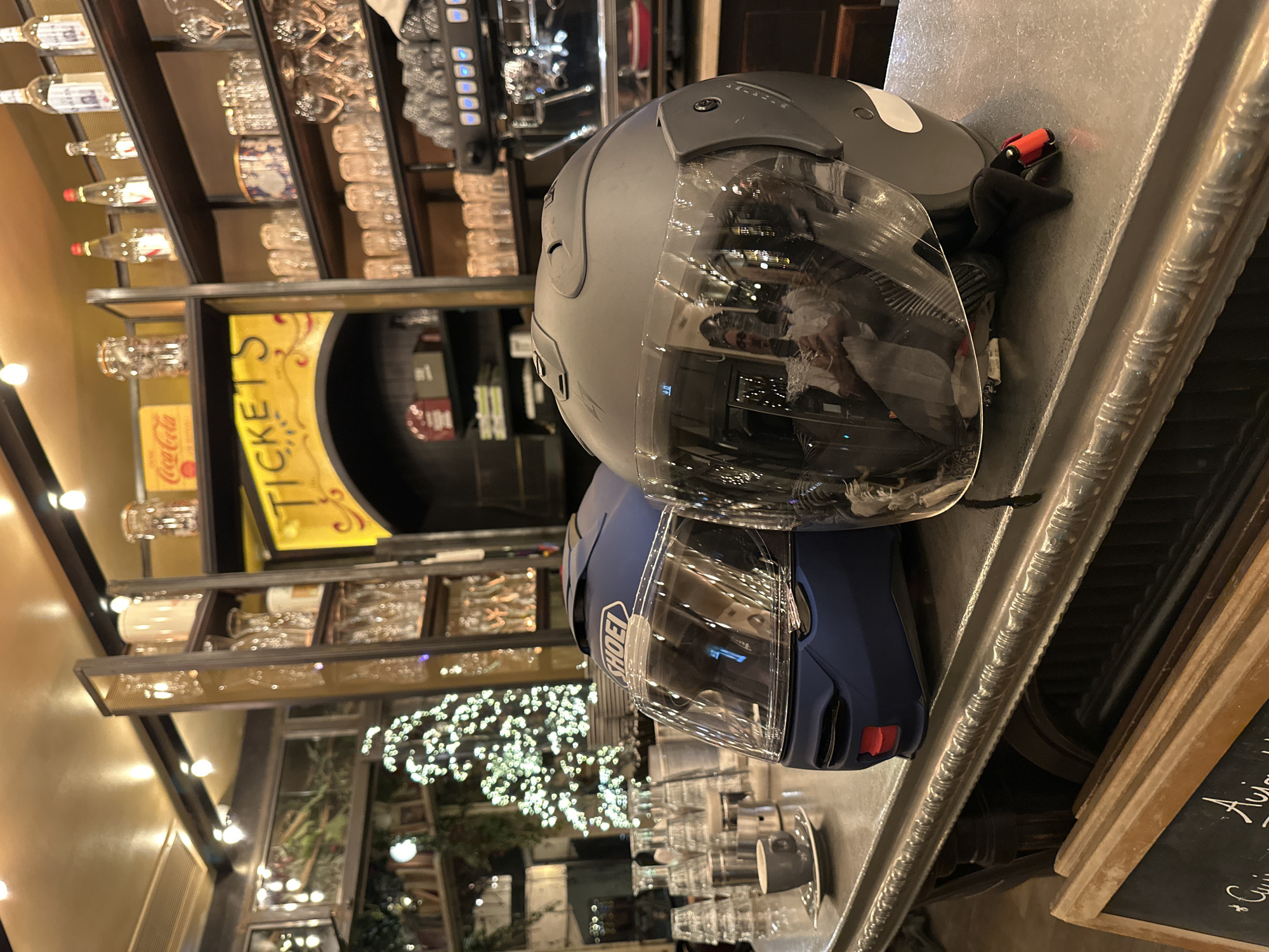 A night out at a Paris bar, helmets parked on the counter.