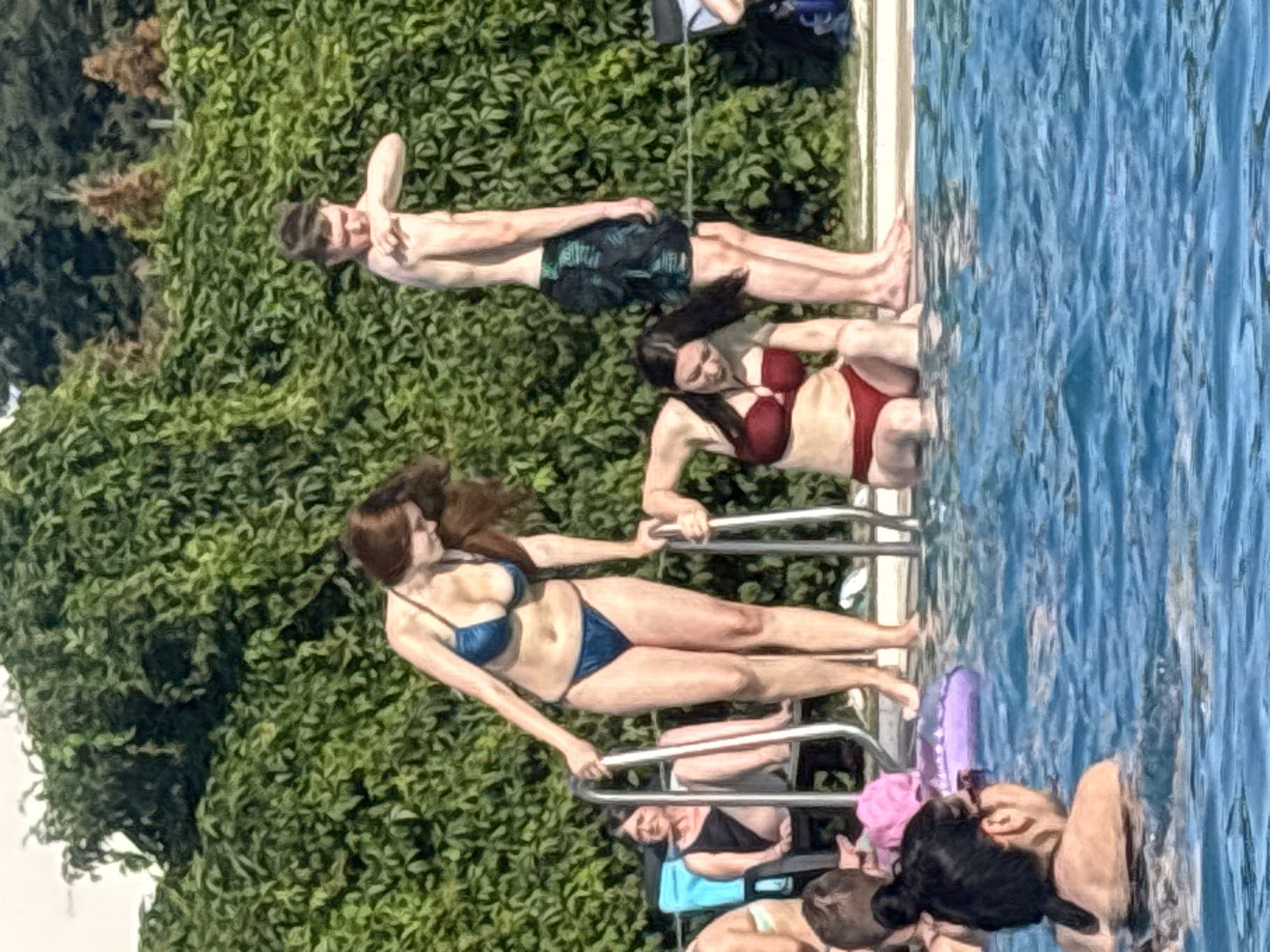 Crowded outdoor pool on a sunny summer afternoon