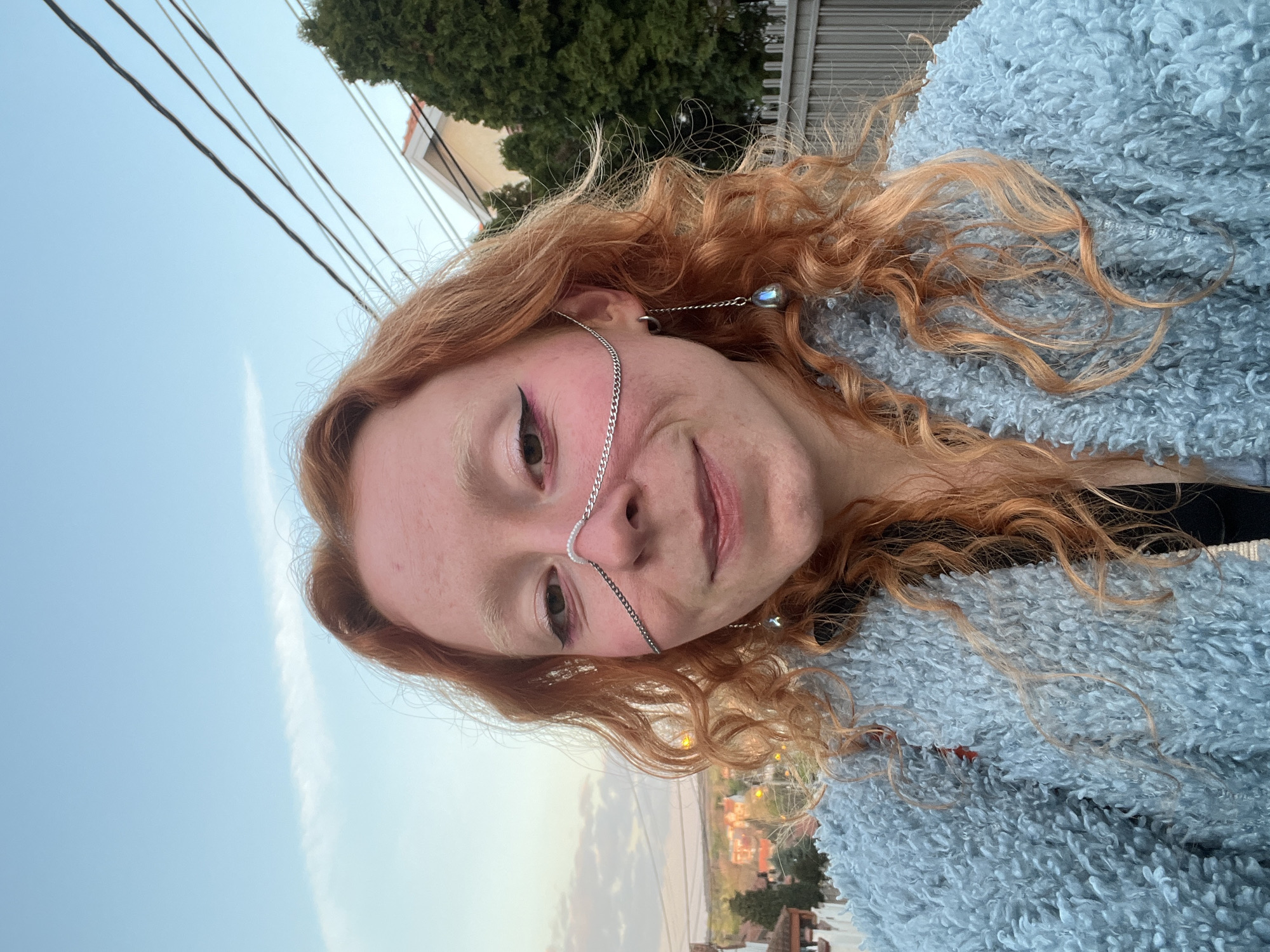 Woman takes selfies with silver chain accessories in Belgrade