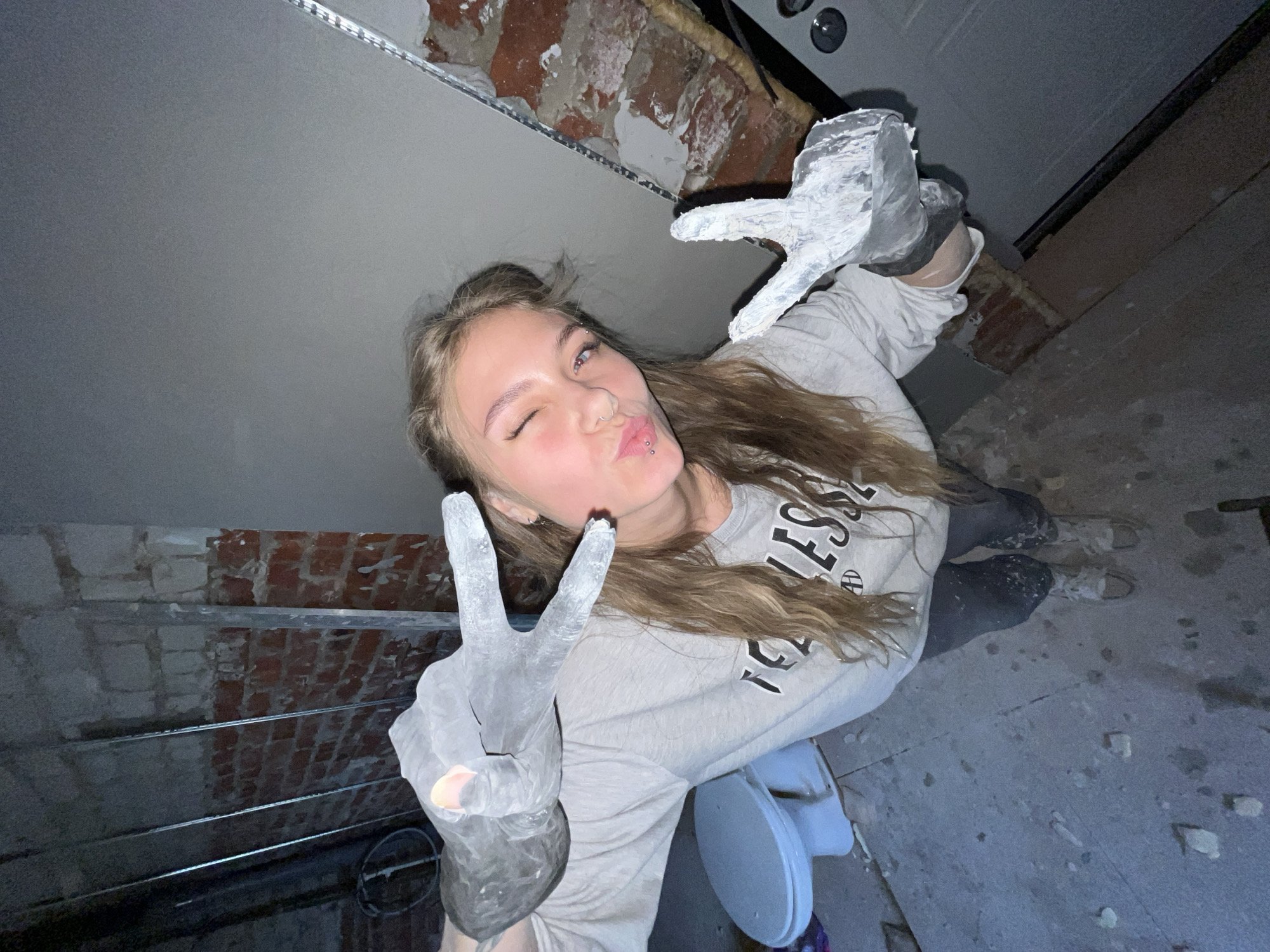 Woman makes peace signs during construction work break