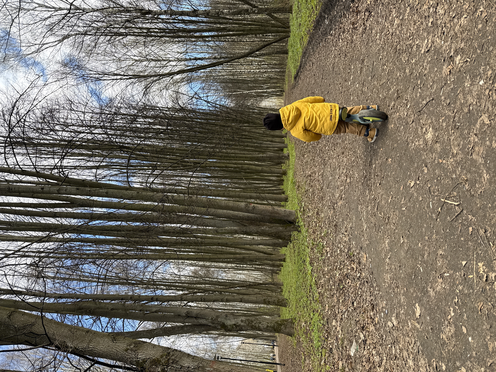 Mother and child enjoy spring morning bike ride in Rusanovo park