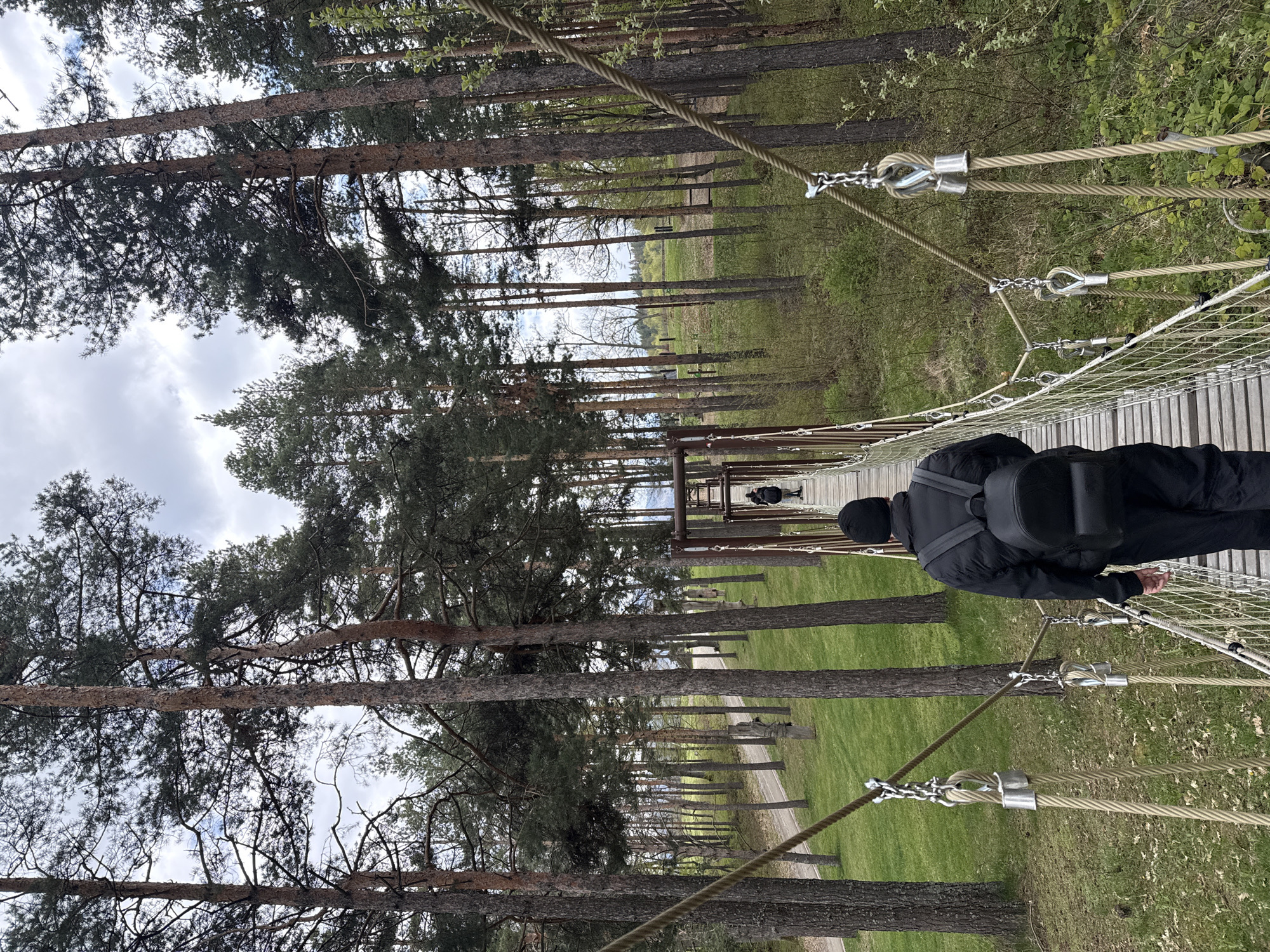 Hiker crosses rope bridge in Bulgarian forest near Belchin