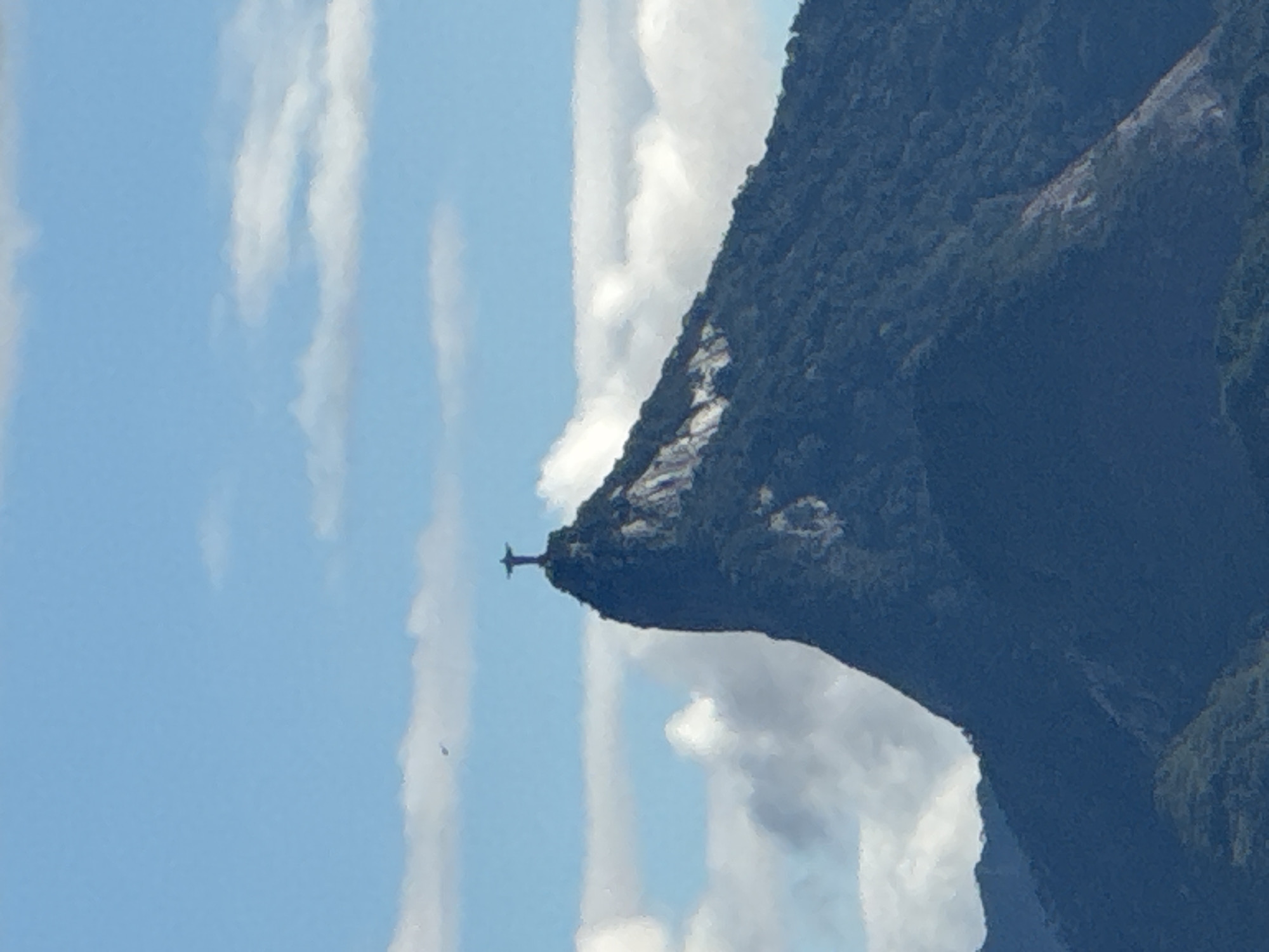 Christ the Redeemer silhouetted against blue sky from Niterói