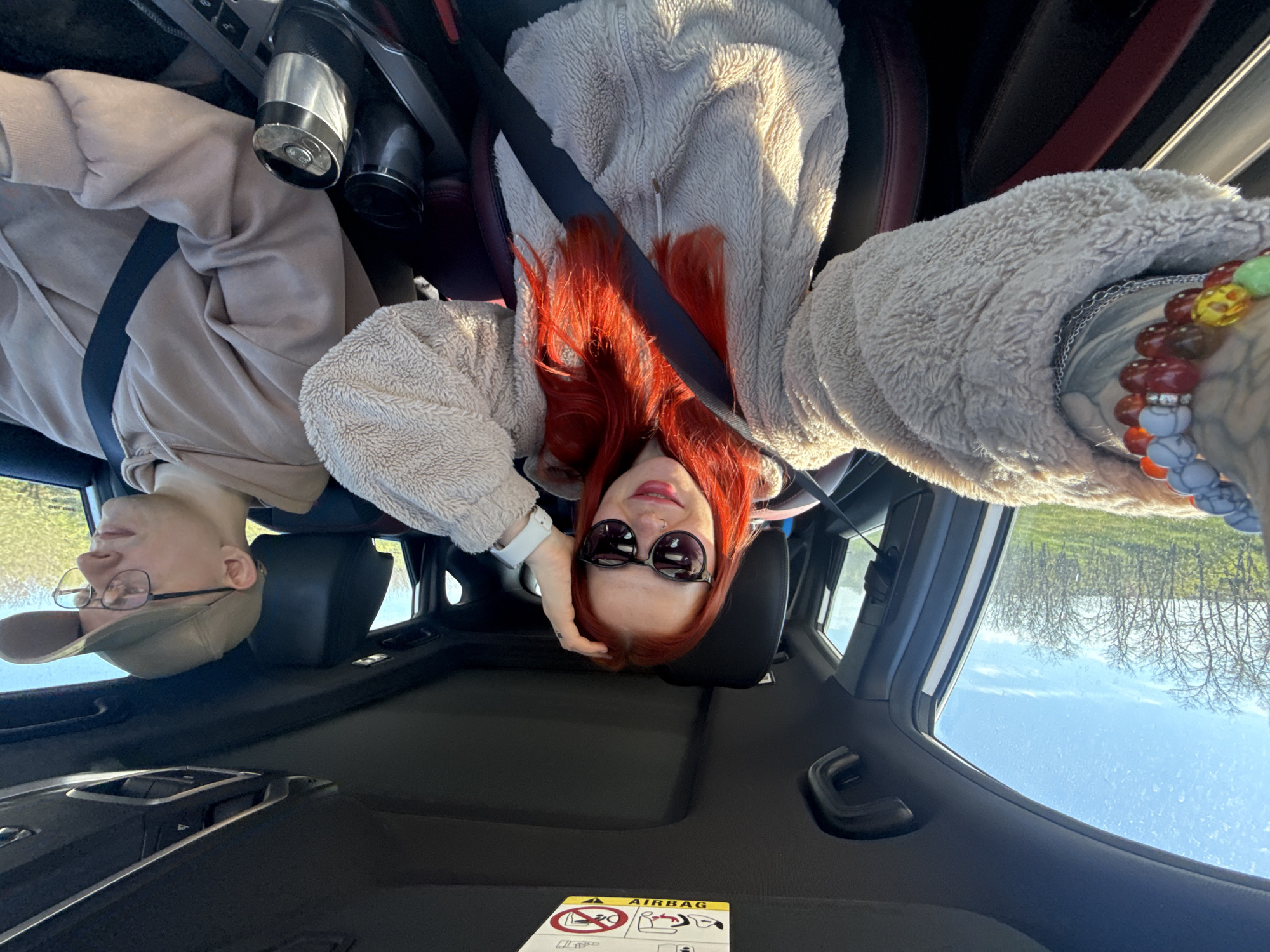 Couple photographed in car during early morning drive in Pokrovskoye