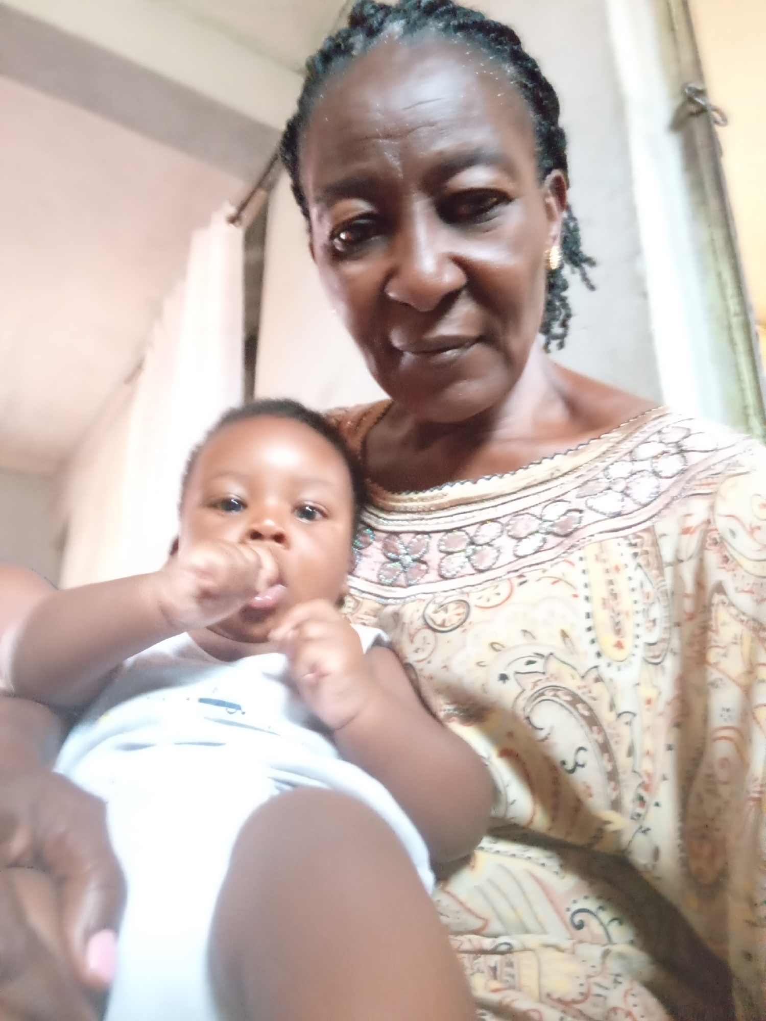 Quiet moments: grandmother with baby, sleeping kitten captured nearby