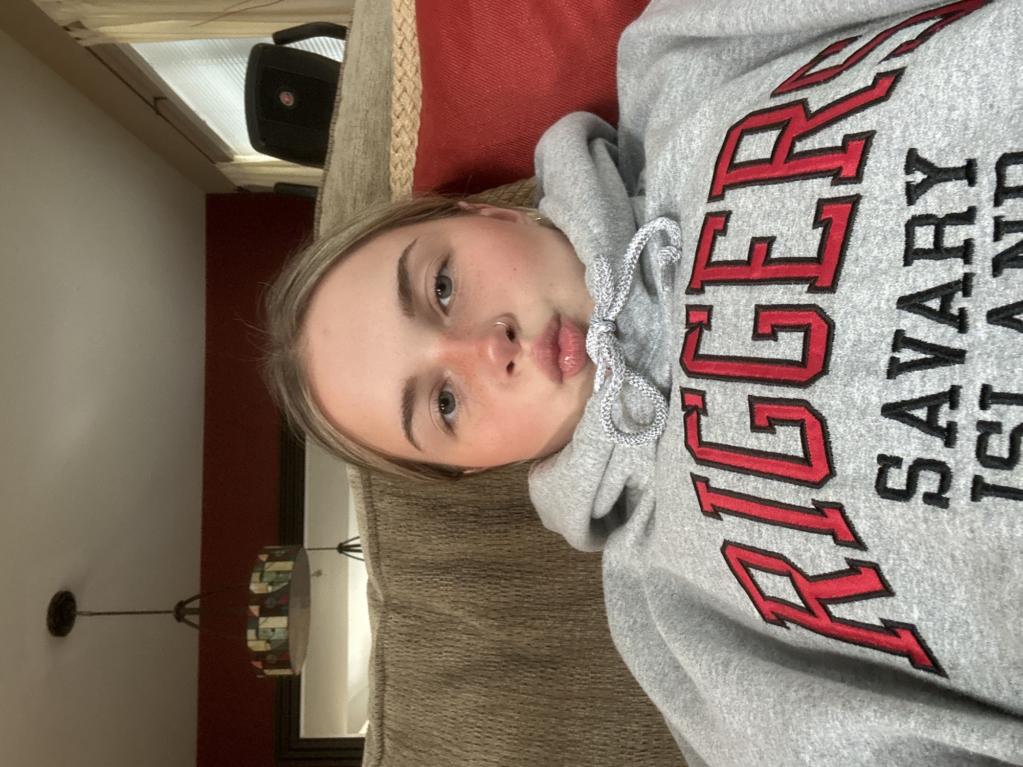 Person in Savary Island sweatshirt rests on couch in Whistler