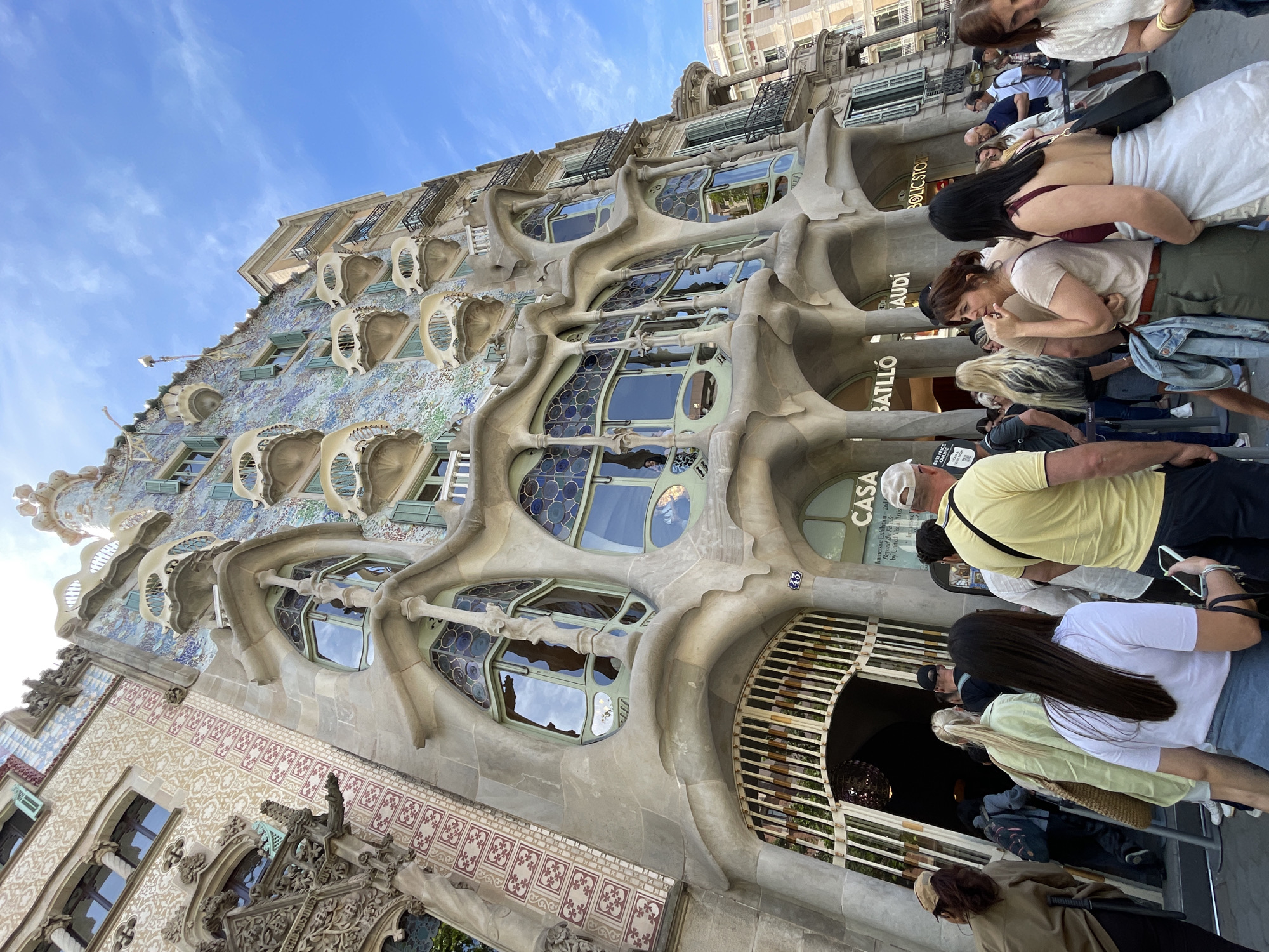 Tourists queue and photograph Casa Batlló in Barcelona