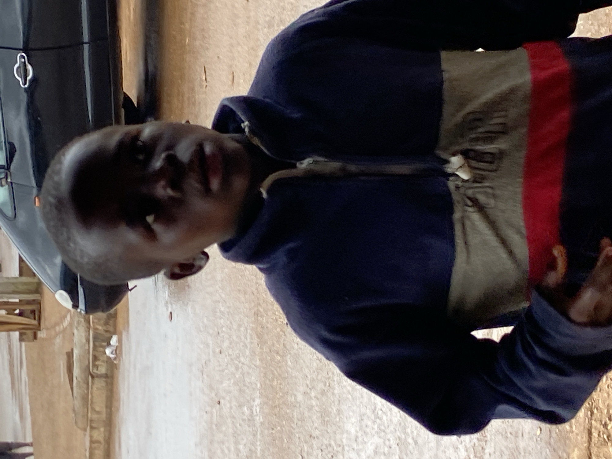 Wet morning street activity in Bukuru, Nigeria