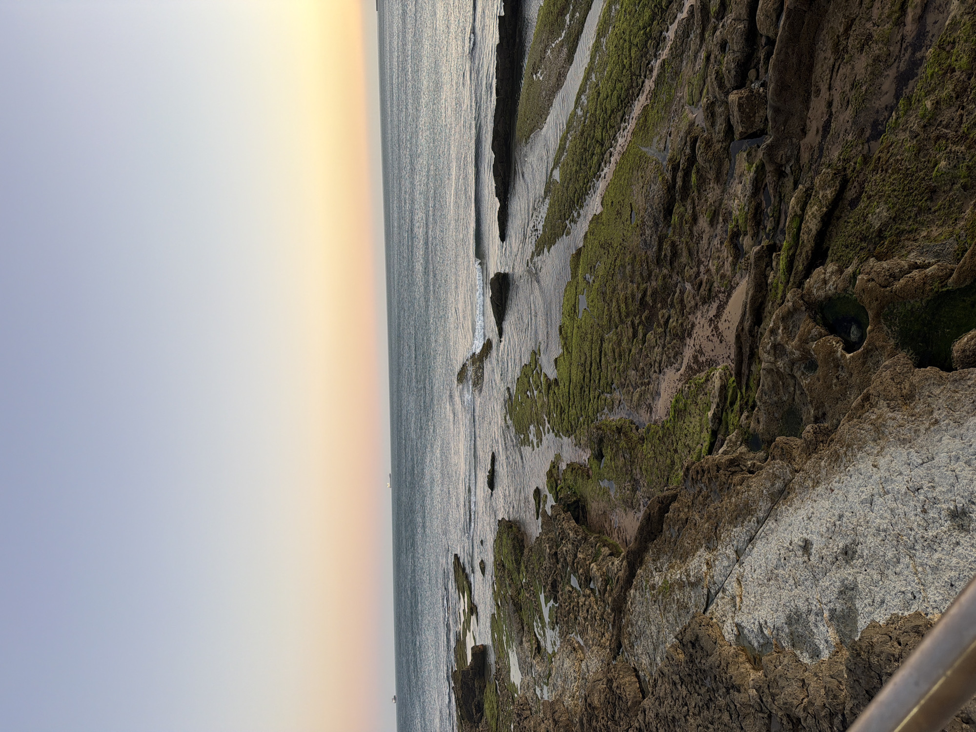 Cascais coastal promenade at golden hour, June 2026