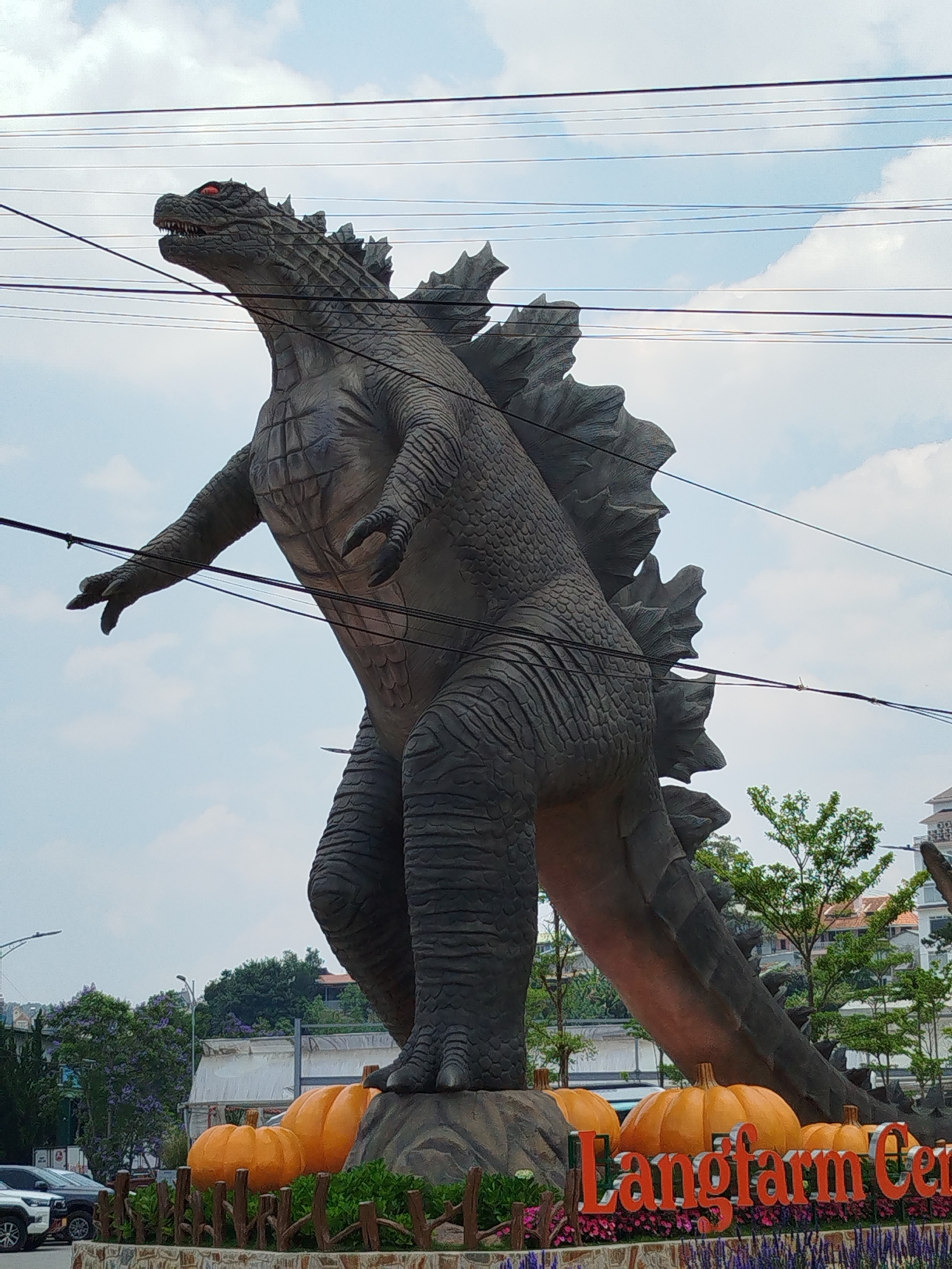 Tourists photograph dinosaur statues at Vietnam garden attraction