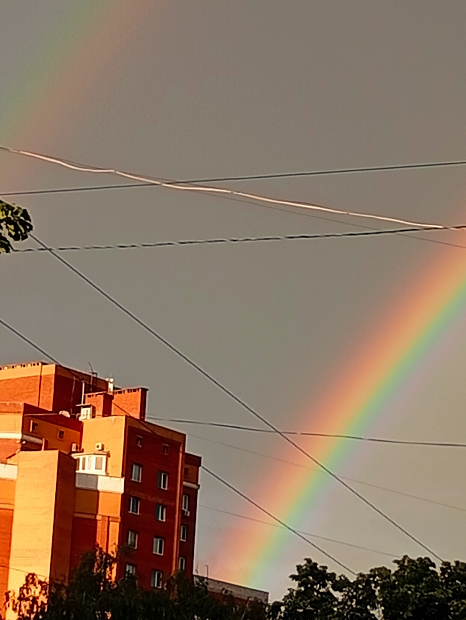 Double rainbow over wet city streets after rain