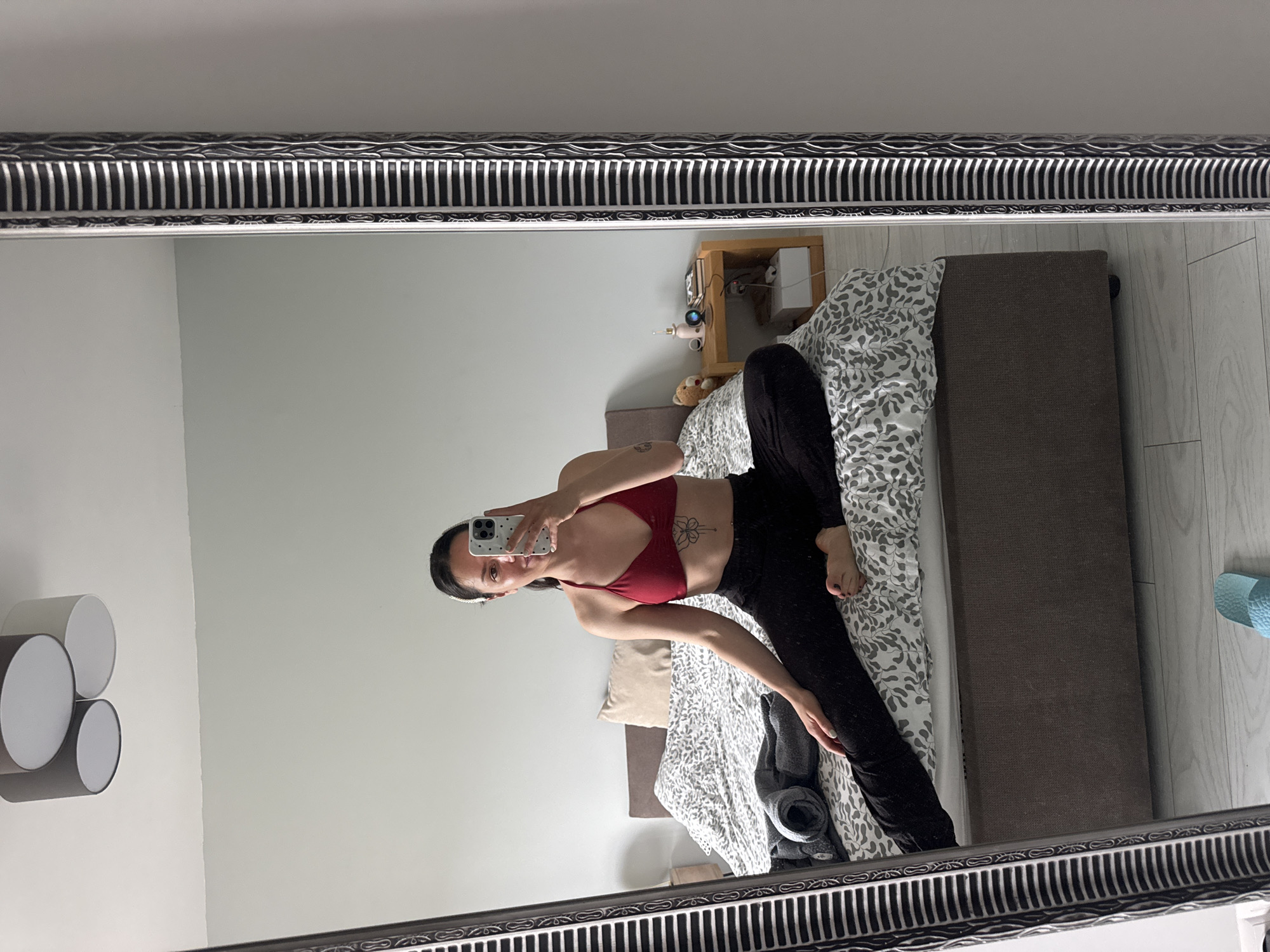 Woman takes playful mirror selfies in Burgas bedroom