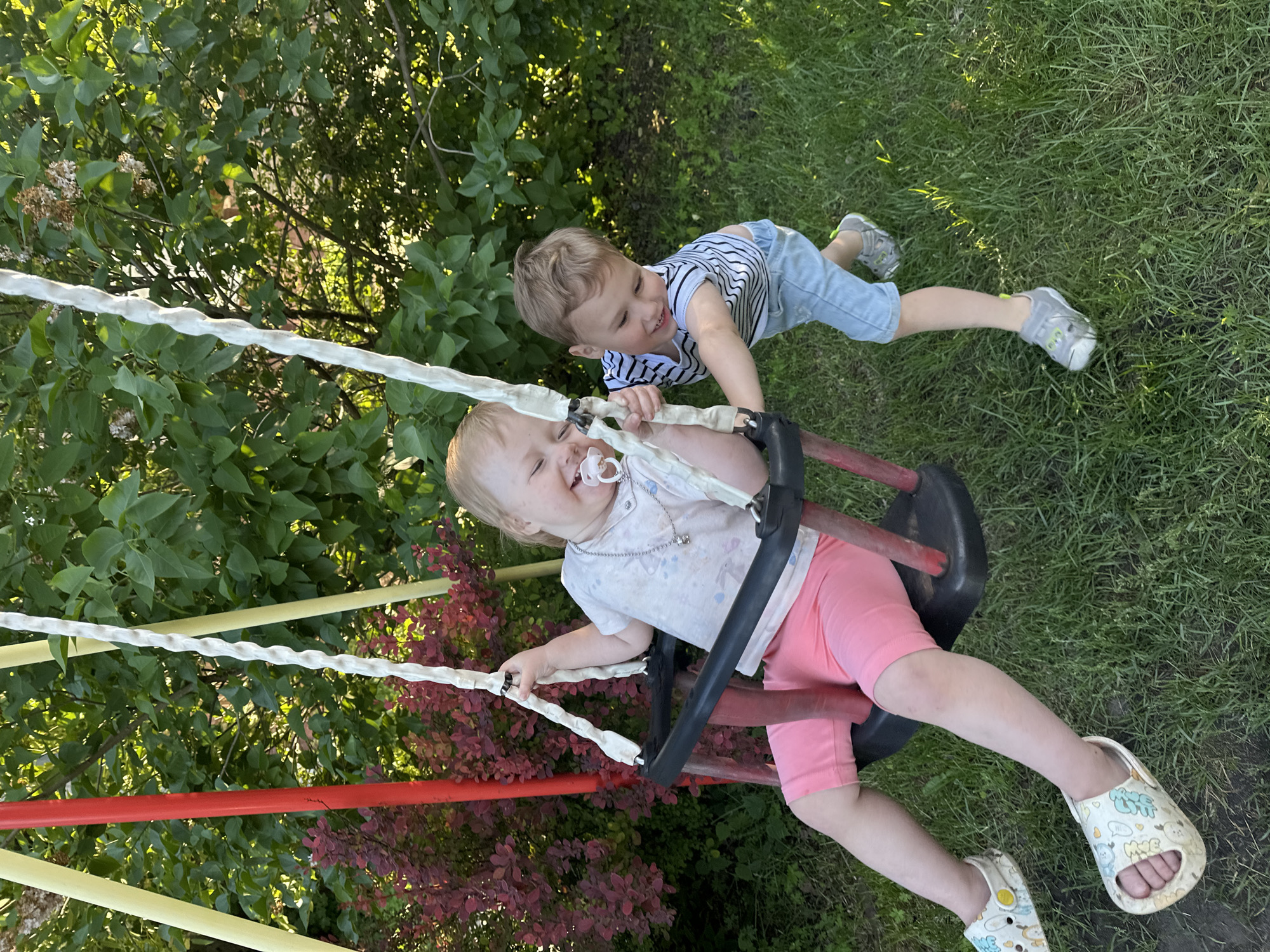 Children play on swings in Nizhny Novgorod playground
