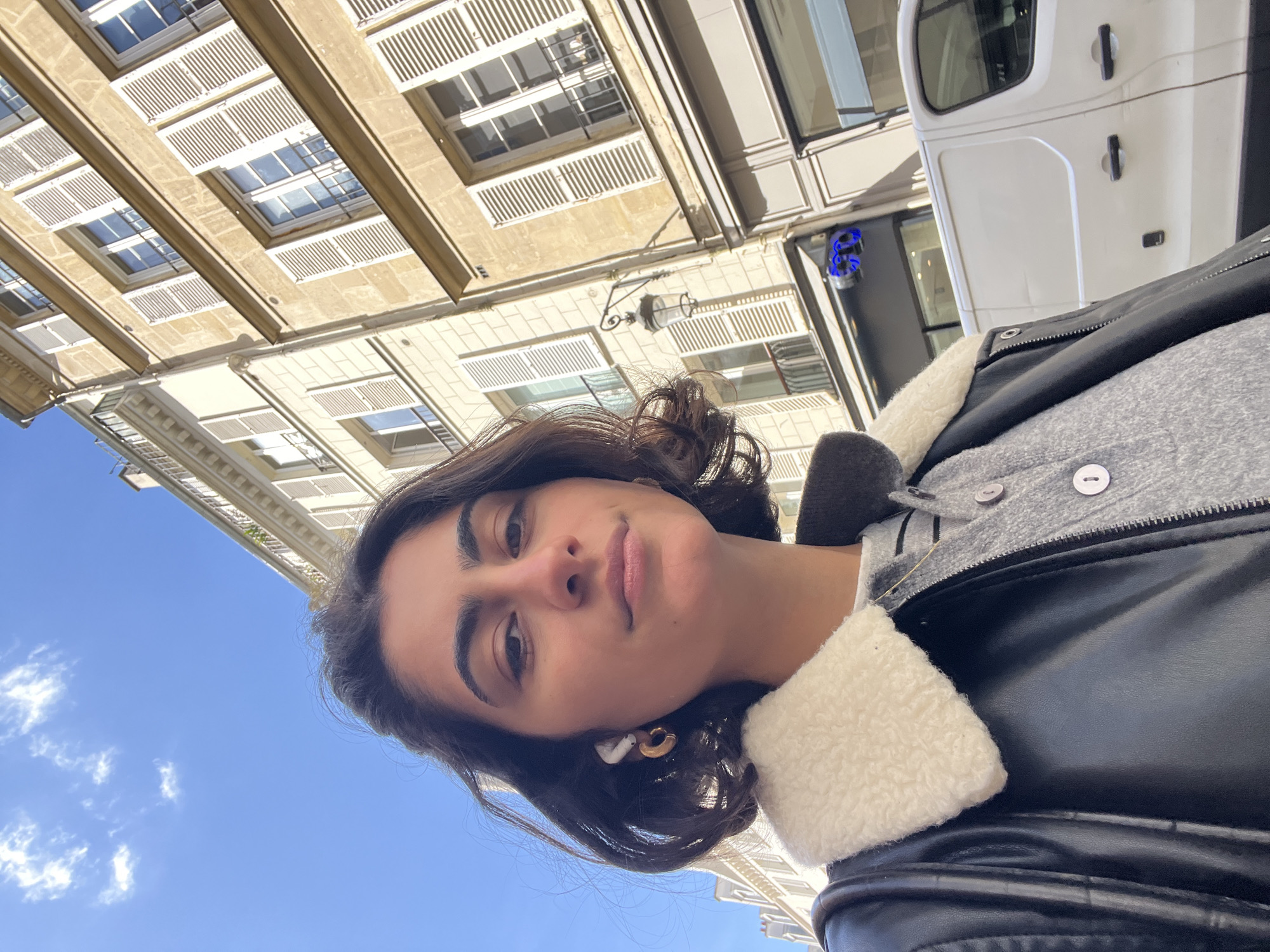 Woman takes selfies on sunny Paris street