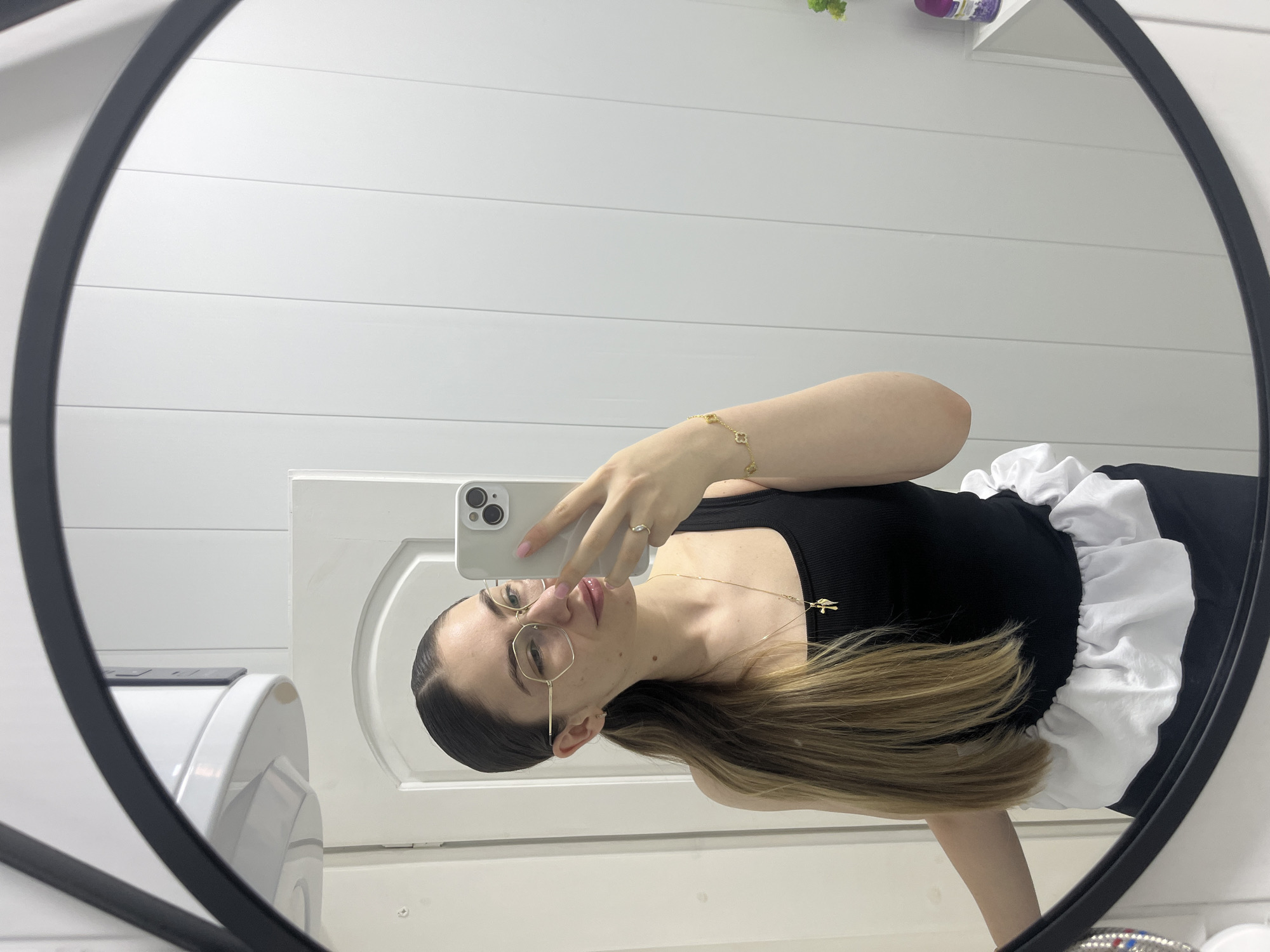 Woman takes mirror selfies in bathroom during morning routine