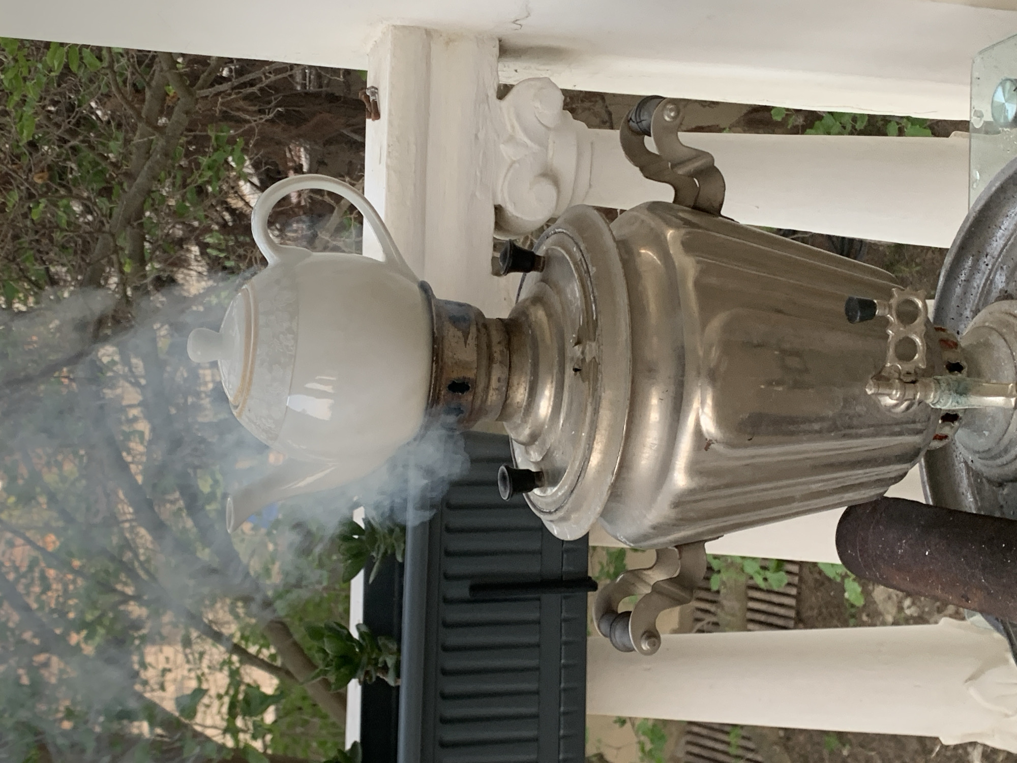Samovar brewing and a tortoise roaming a balcony planter in Azerbaijan