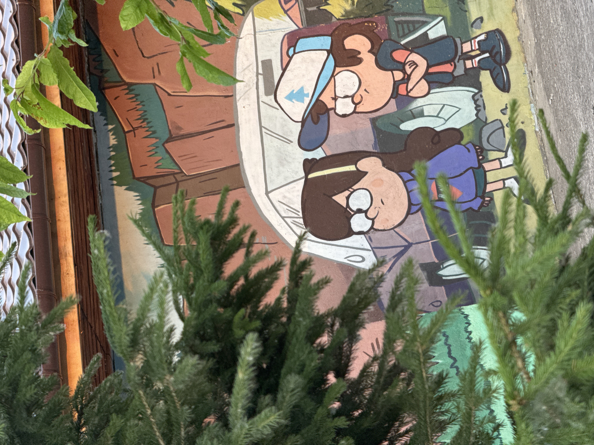 Afternoon in a Krasnoyarsk park with cartoon murals and greenery