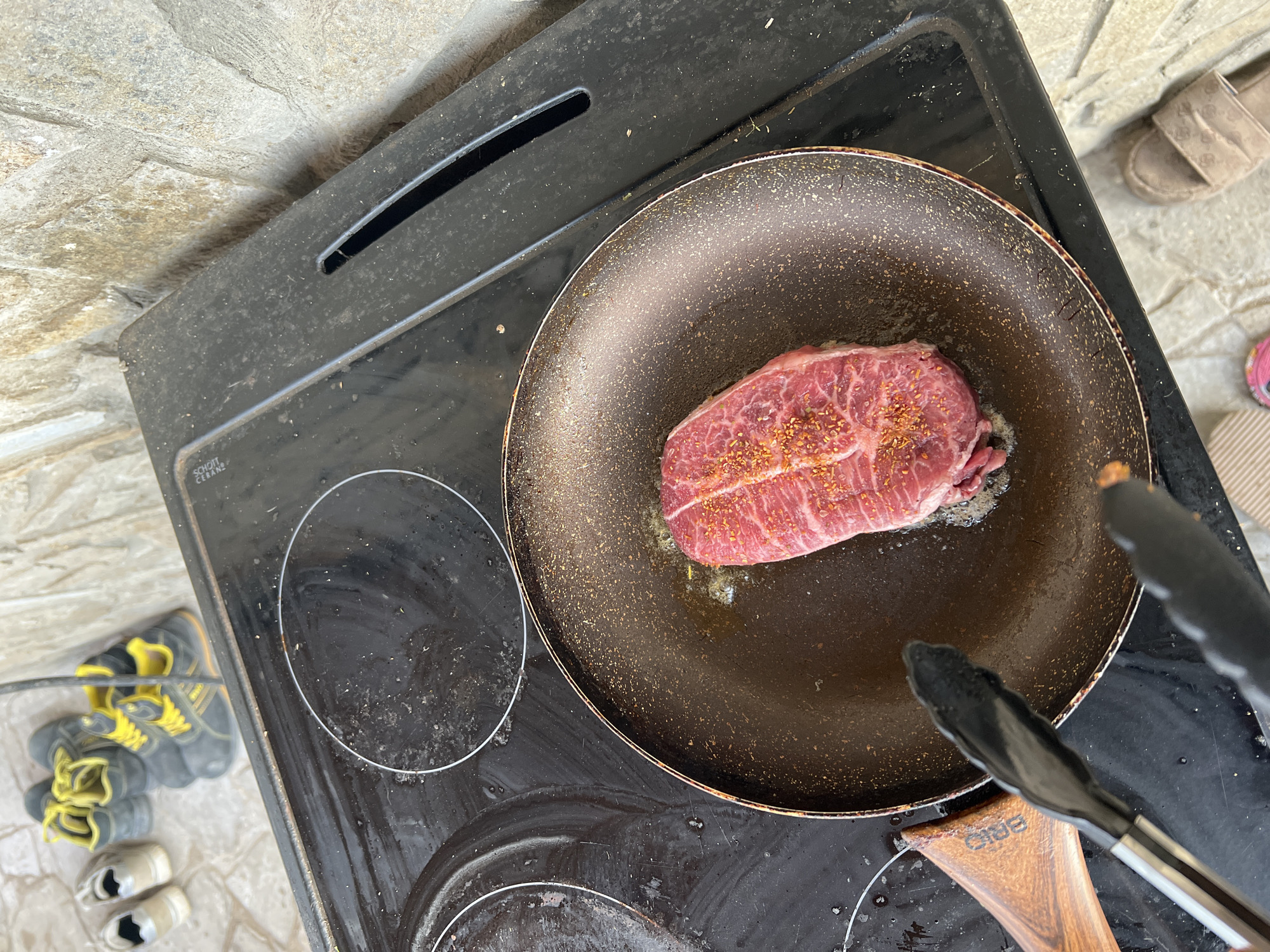 Man cooks steak outdoors in Shumata, Bulgaria
