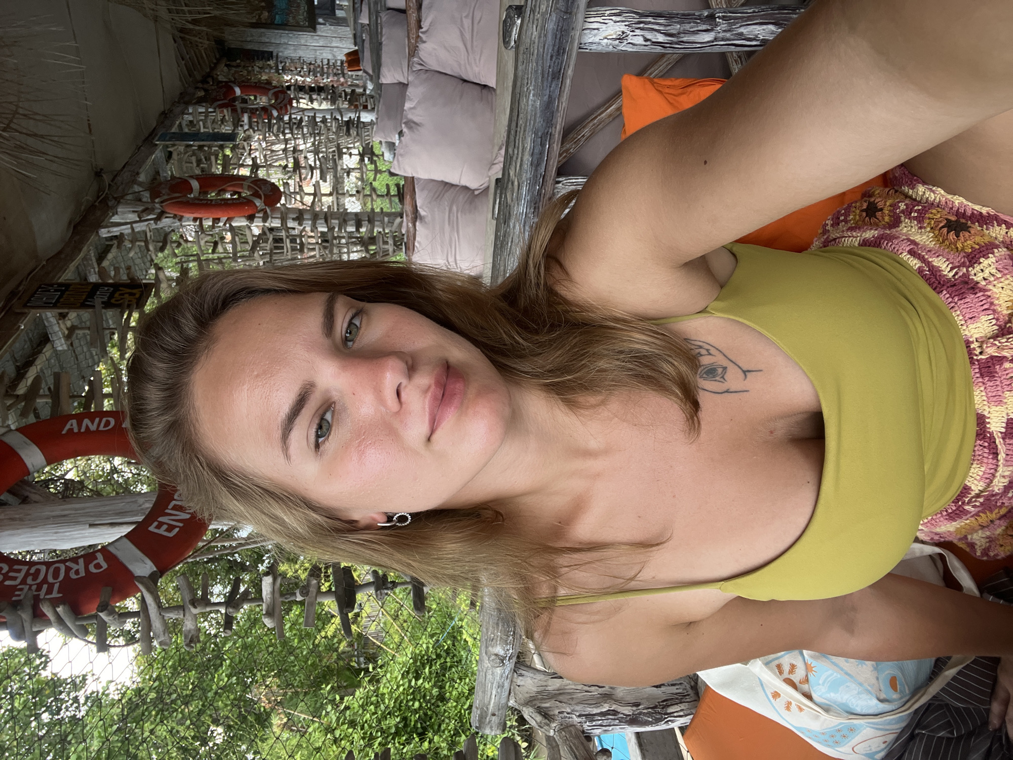 Woman takes selfie at beachside cafe in Buleleng
