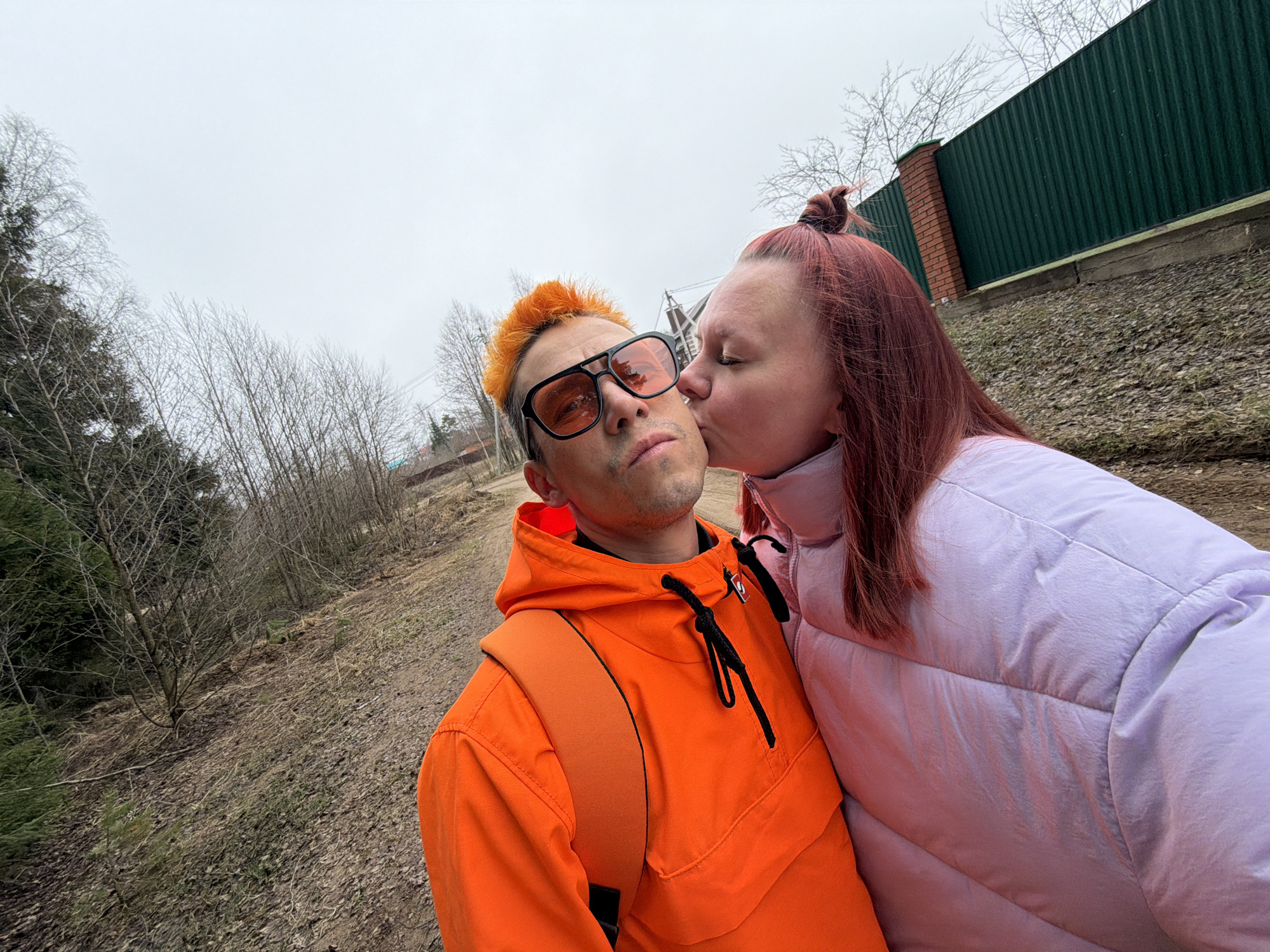 Couple takes selfies in overcast Chaikovsky, sleeping dog captured