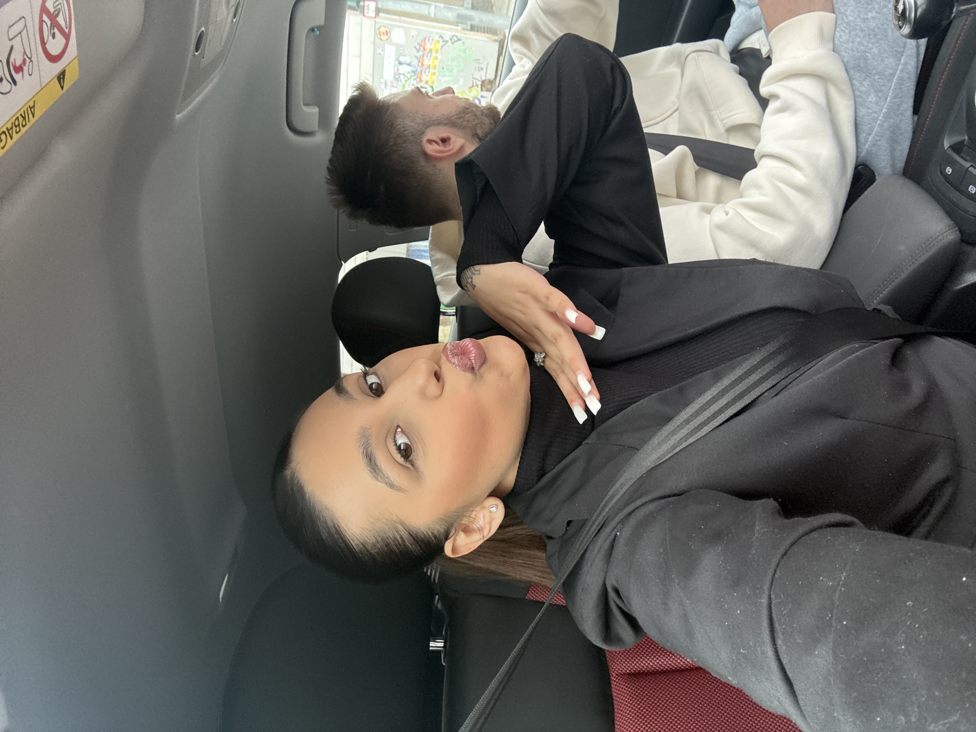 Woman takes selfie with passenger in car, Mönchengladbach