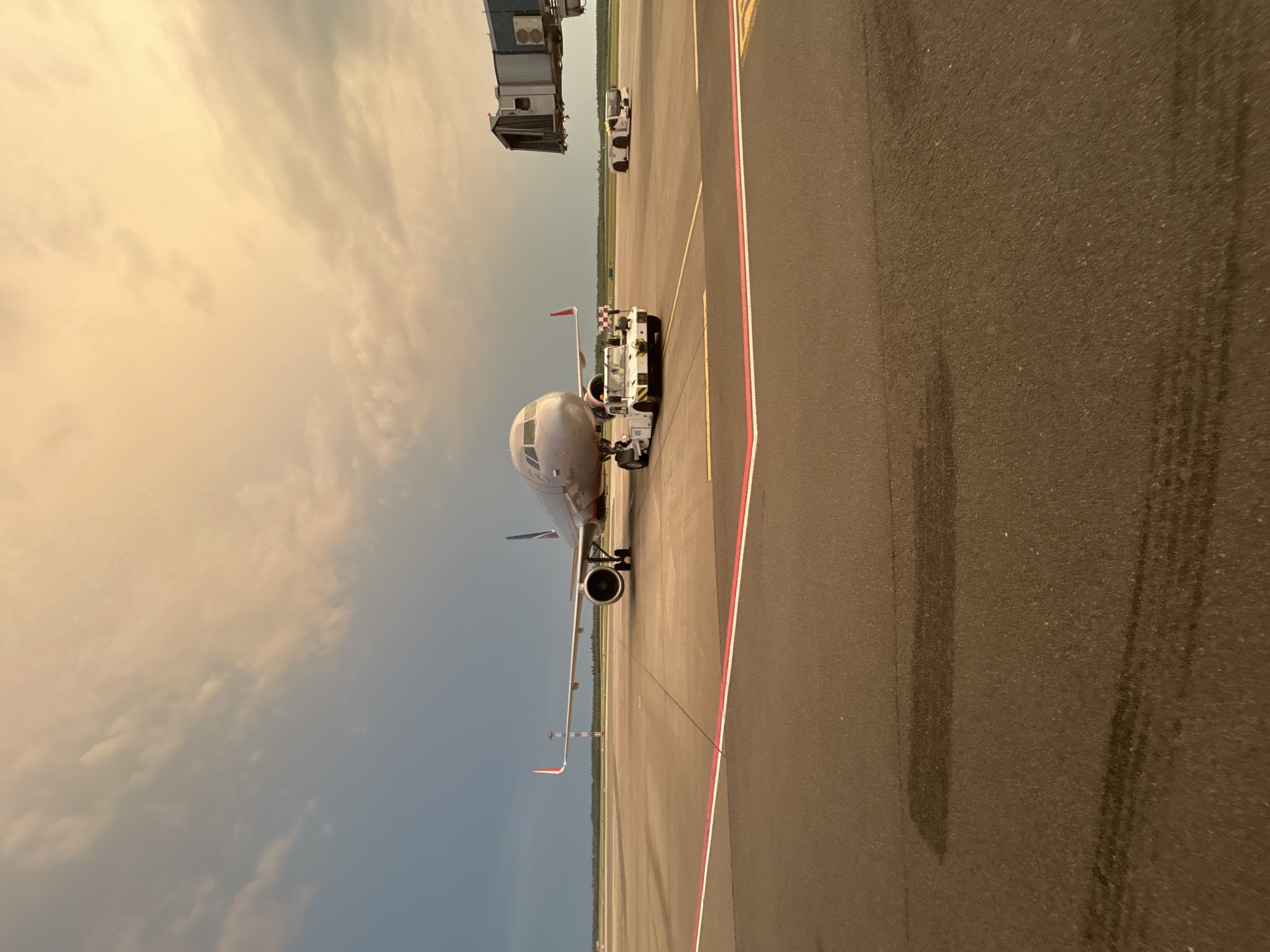 Aircraft towed at dusk on Minsk airport tarmac