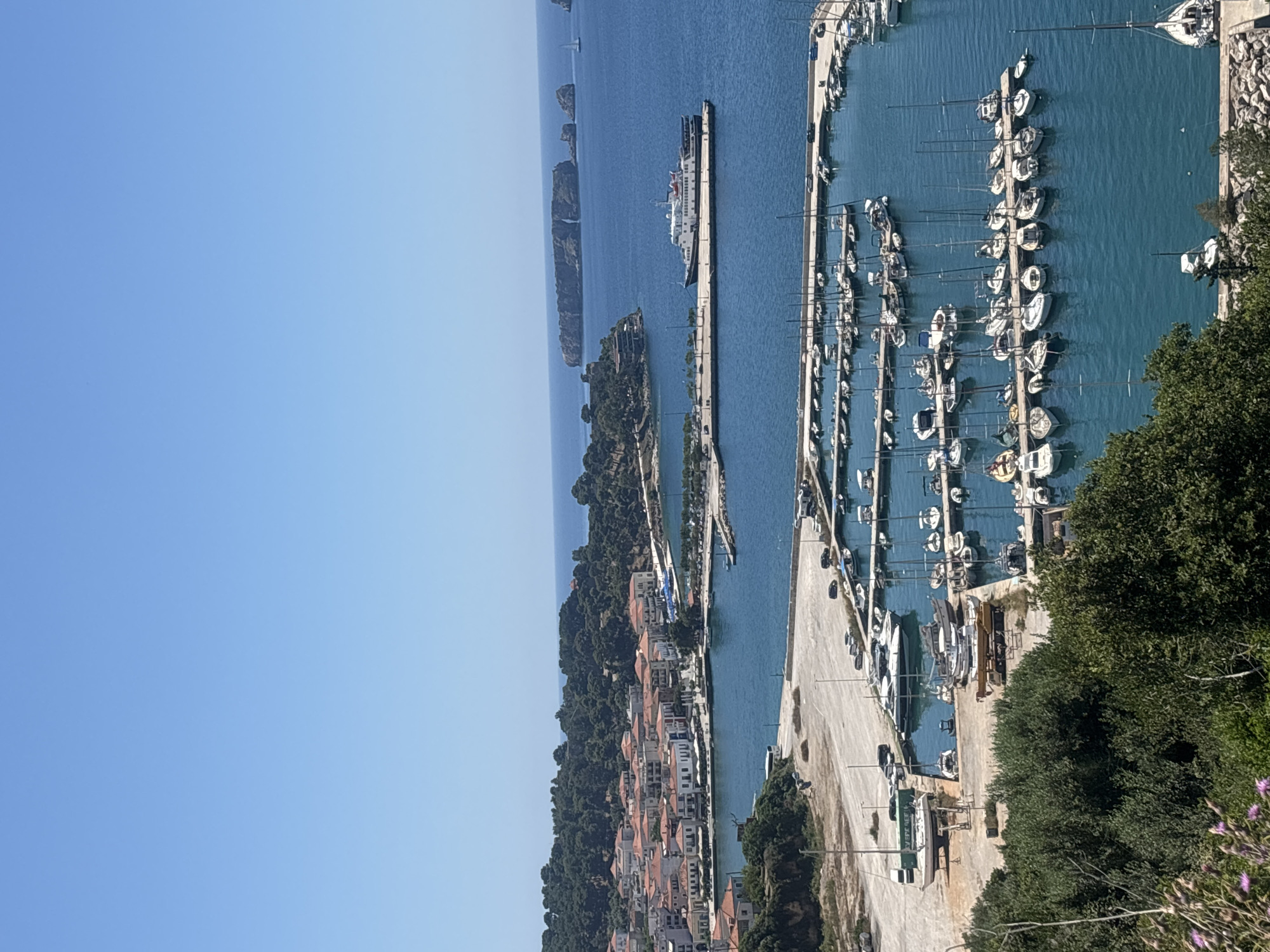 Peaceful morning at Pylos marina captures sailboats and ferry