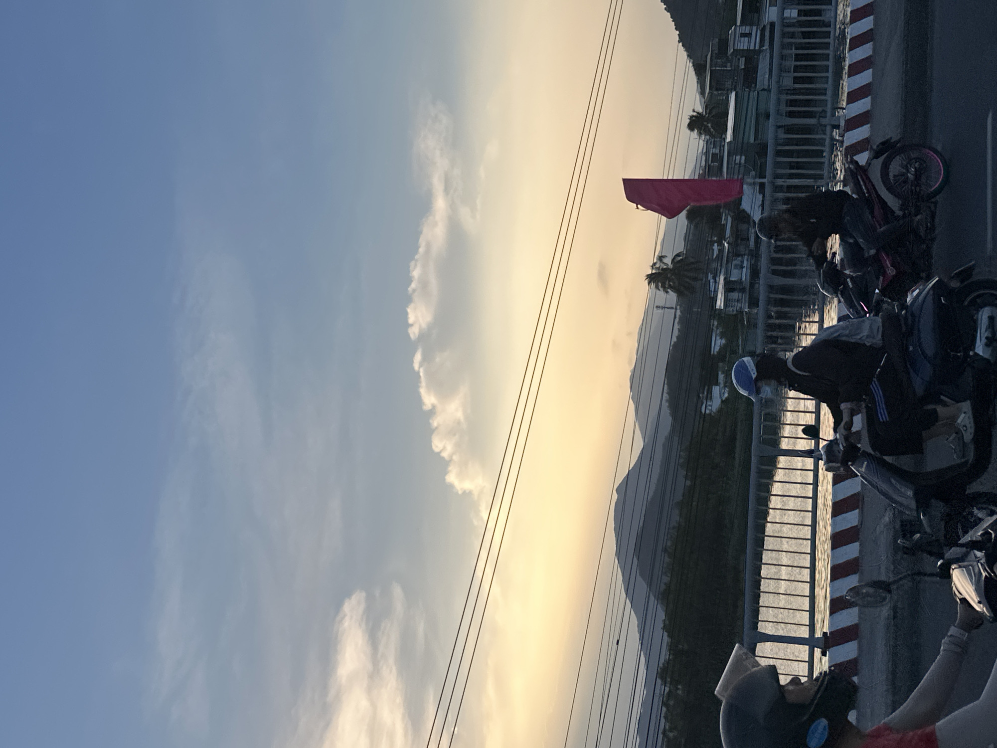Motorbikes gather on bridge during sunset in Nha Trang