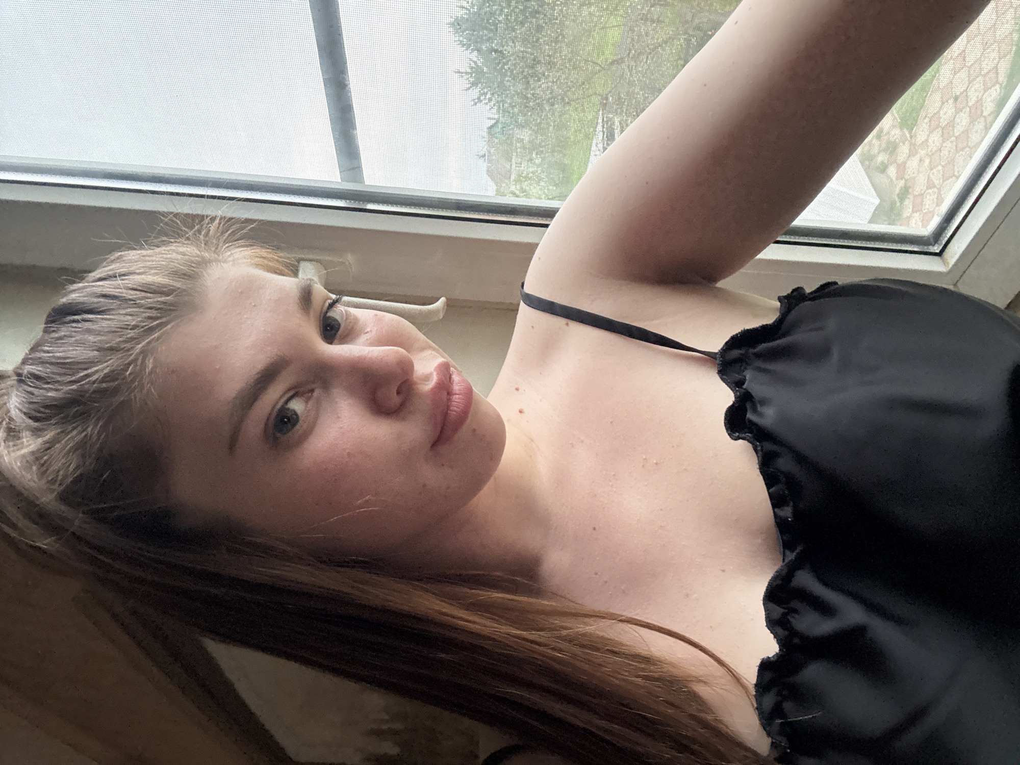 Woman takes selfies by window in Мещёры, Russia
