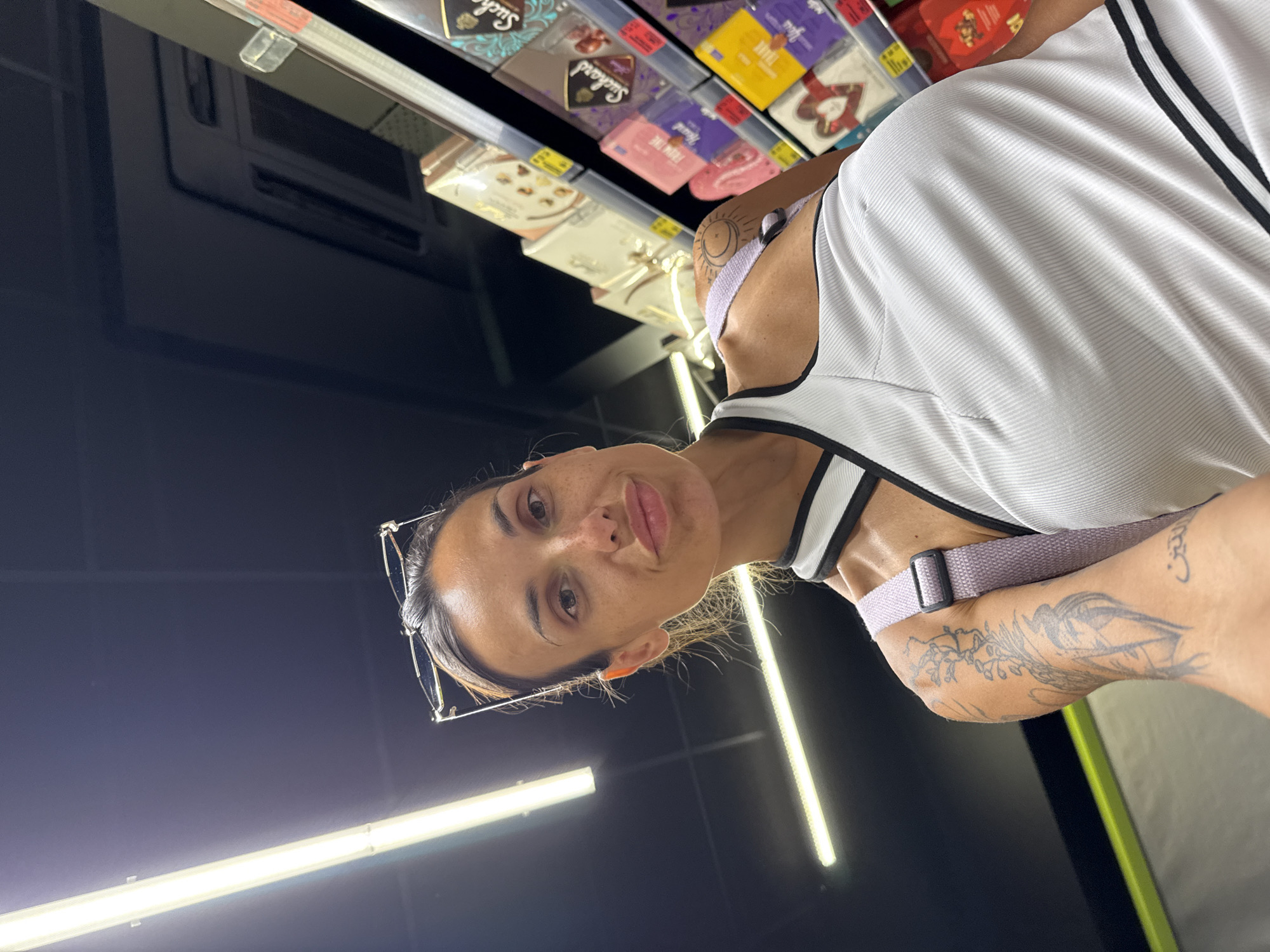 Selfie moment in a well-lit Pleven grocery store aisle