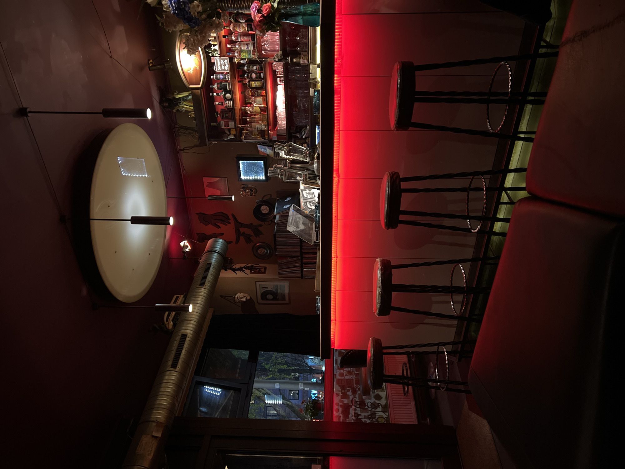 Berlin bar patrons gather amid retro decor, roller skate projections