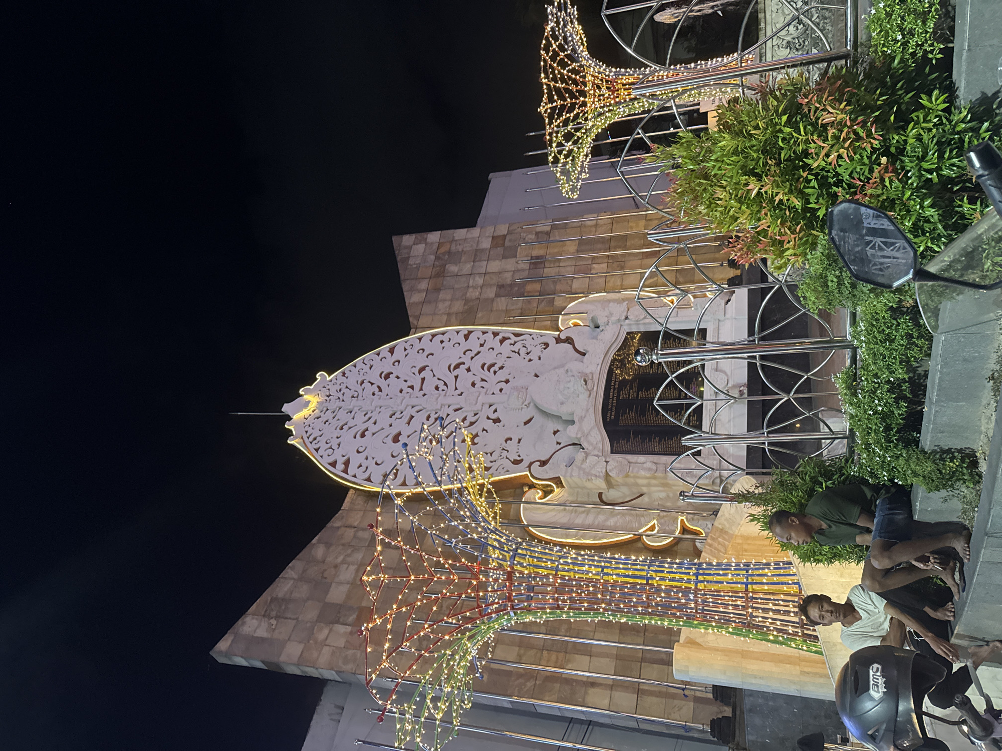 Kuta at night: memorial lights, thatched bars, and street-level scenes