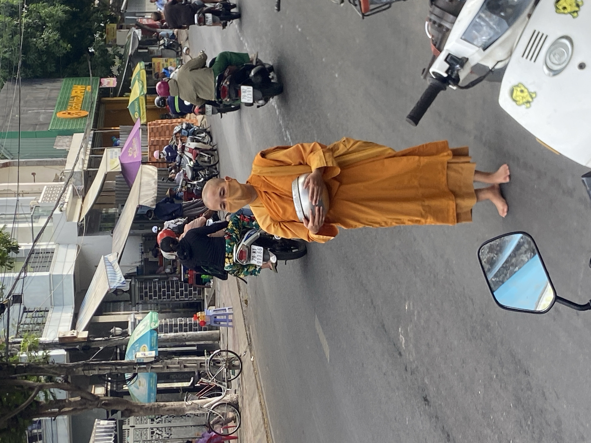 Buddhist monk with alms bowl on a Nha Trang street